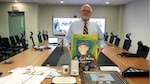 Employee displays his gifts of appreciation after retirement ceremony.