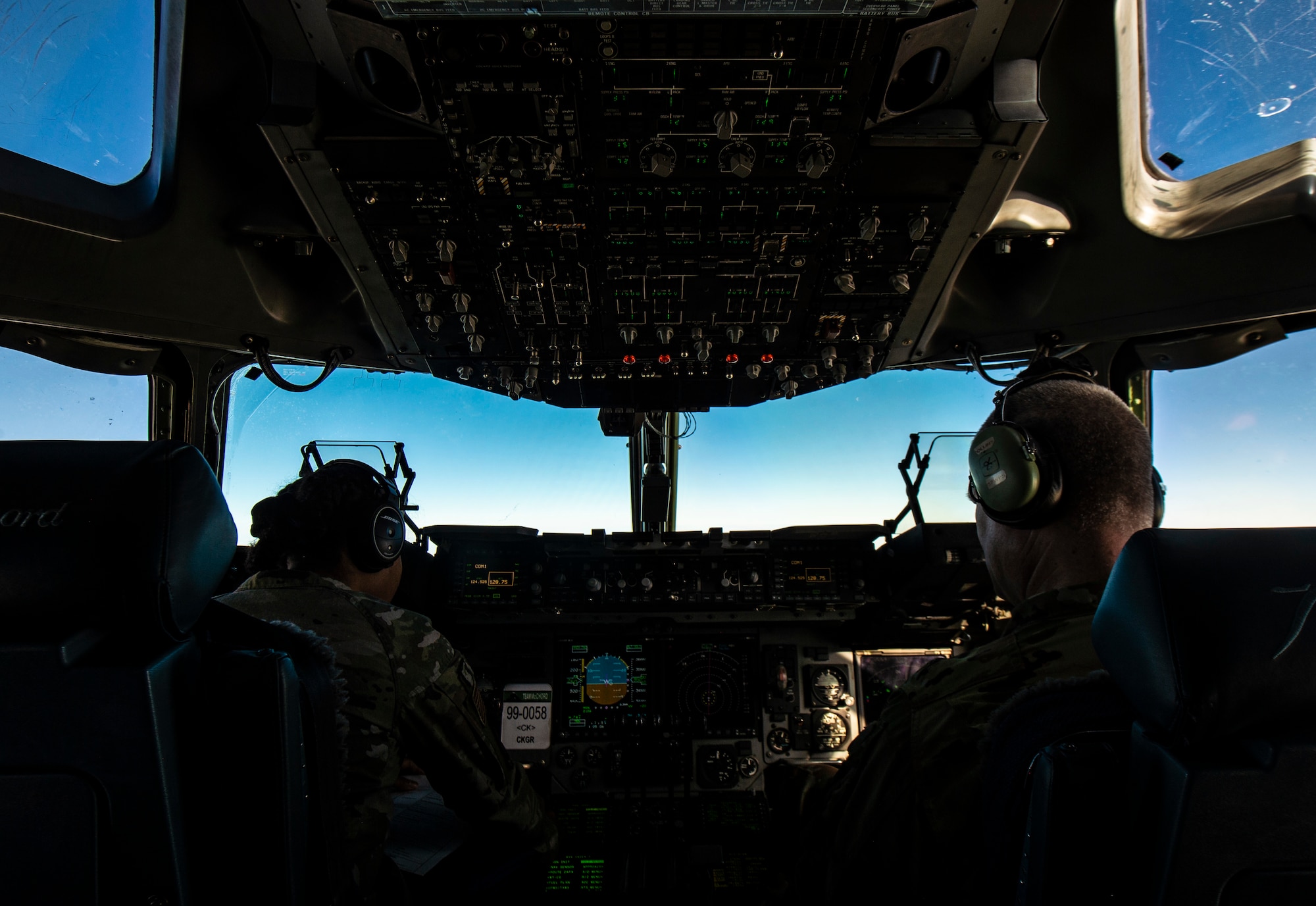 U.S. Air Force 1st Lt. Erica Drakes, 4th Airlift Squadron pilot, left, and U.S. Air Force Col. Brian Collins, 62nd Airlift Wing vice commander, fly a C-17 Globemaster III carrying Airmen assigned to Joint Base Lewis-McChord, Washington; Joint Base McGuire-Dix-Lakehurst, New Jersey; and Dover Air Force Base, Delaware, deploying to the 816th Expeditionary Airlift Squadron at Al Udeid Air Base, Qatar, Nov. 28, 2021. Drakes remained in Qatar as a member of the 816th EAS, while Collins was a part of the air crew returning those who had finished their deployment home. (U.S. Air Force photo by Staff Sgt. Tryphena Mayhugh)