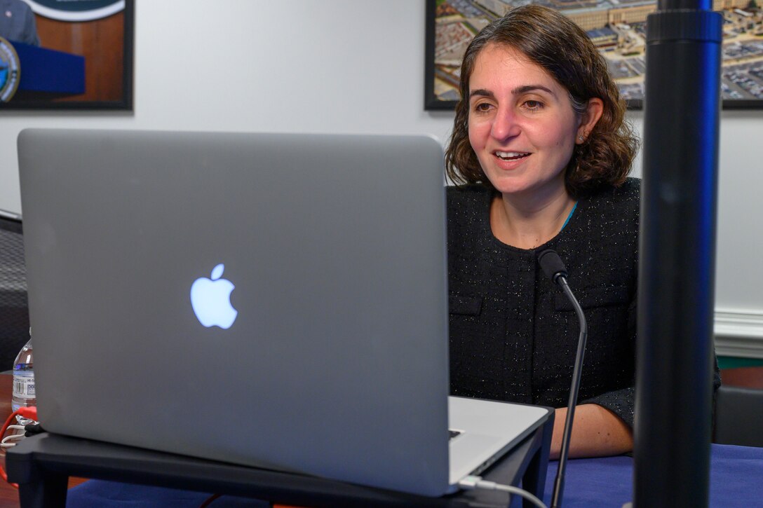 A woman gives remarks during a virtual event.