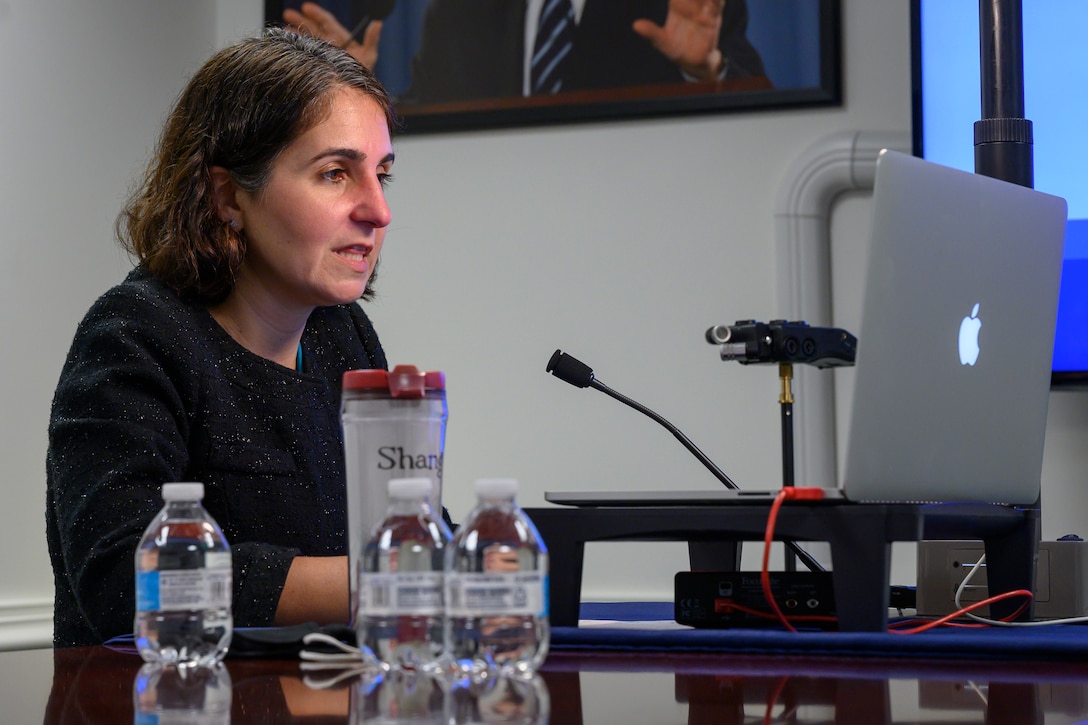 A woman gives remarks during a virtual event.