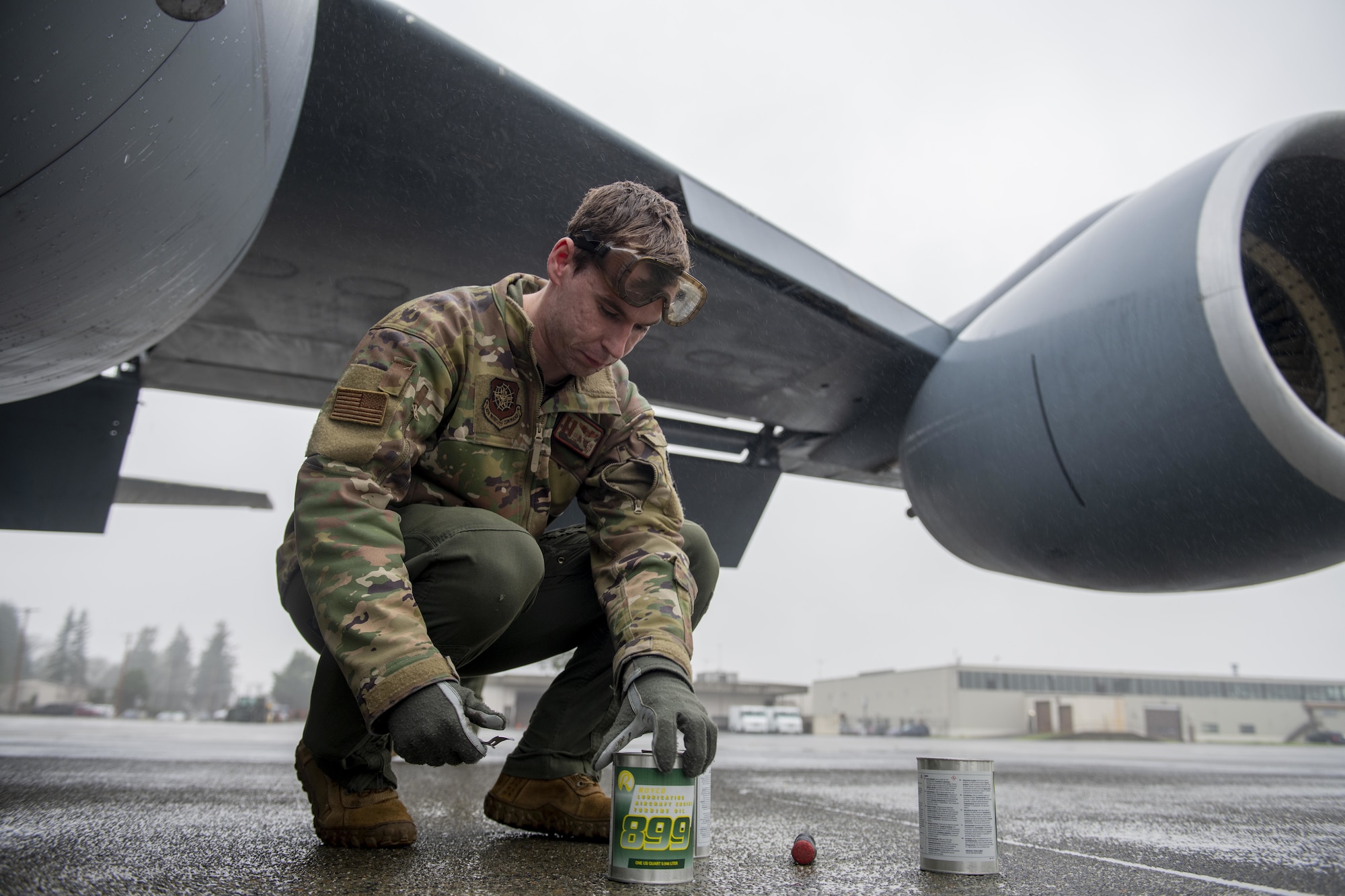 U.S. Air Force Capt. Colin Strickland, 92nd Air Refueling Squadron KC-135 Stratotanker pilot, prepares to service a KC-135 during a large-scale readiness exercise at Joint Base Lewis-McChord, Washington, Dec. 7, 2021. Multiple crews from Fairchild Air Force Base flew to various locations to train and exercise multi-capable Airmen concepts, such as aircrew Airmen performing routine maintenance tasks on the KC-135. (U.S. Air Force photo by Staff Sgt. Lawrence Sena)