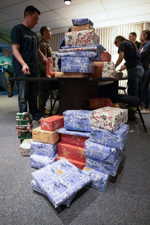 Team Thule members work together to organize wrapped gifts in preparation for delivery to local villages at Thule Air Base, Greenland, Nov. 6, 2021. Gifts will be distributed to four local villages and delivered to the local children. (U.S. Air Force photo by Staff Sgt. Carlos Ferran)