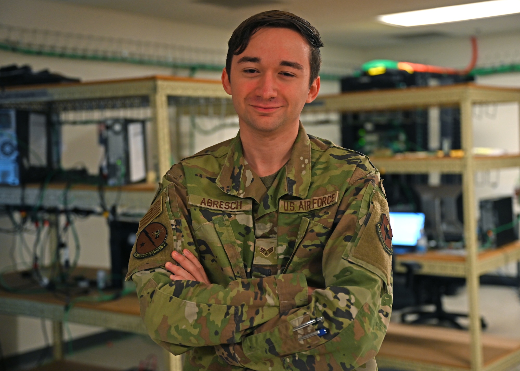 U.S. Air Force Senior Airman Justin Abresch, 17th Communications Squadron client systems technician, poses for a portrait in the 17th CS reimaging lab, Dec. 9, 2021. Abresch was recognized for his efforts in restoring mobile phone support and working with his squadron during the intel course rewrite. (U.S. Air Force photo by Senior Airman Ethan Sherwood)