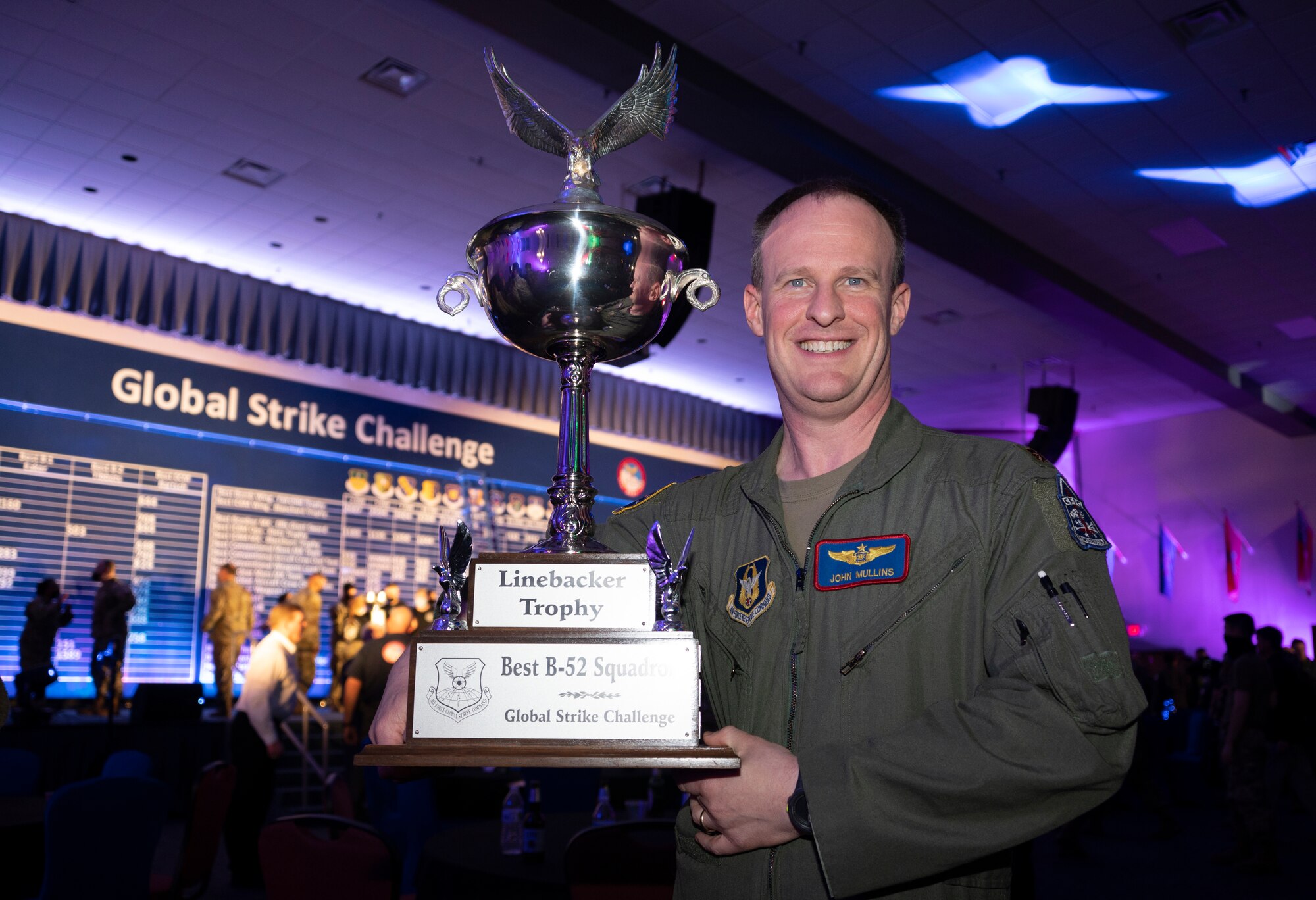 Photo of Airman holding trophy