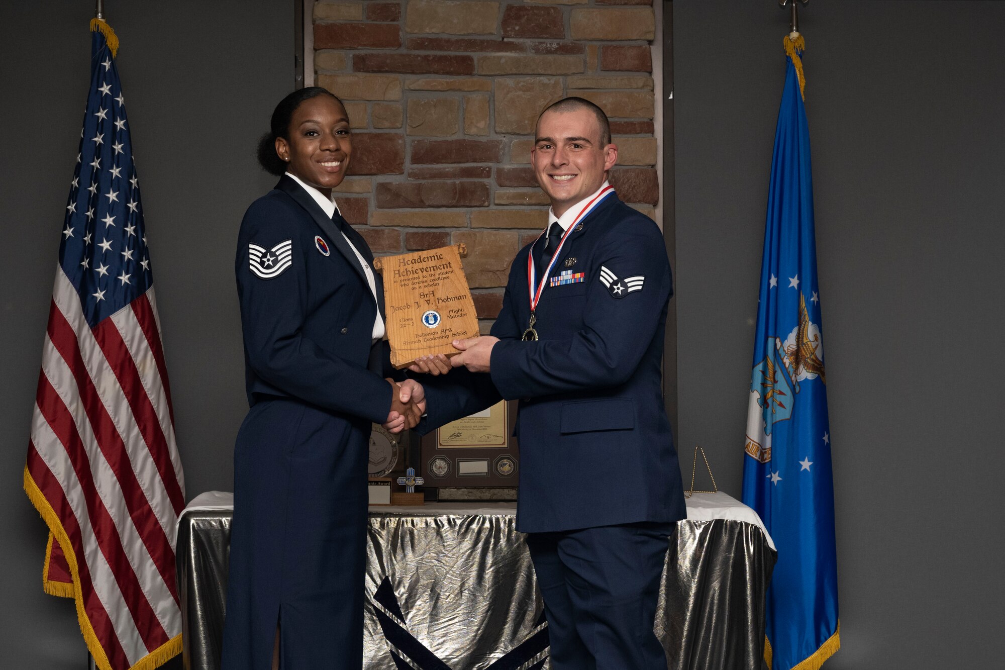 Senior Airman Jacob J. V. Hohman, Airman Leadership School graduate, accepts the academic achievement award during the graduation of ALS class 22-2, Dec. 9, 2021, on Holloman Air Force Base, New Mexico. The academic award is presented to the student with the highest overall average on all academic evaluations. (U.S. Air Force photo by Senior Airman Kristin Weathersby)