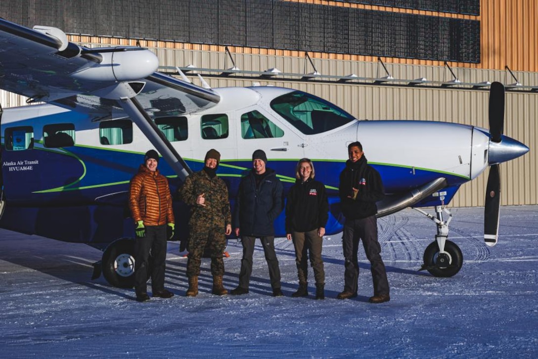 U.S. Marines in support of Toys for Tots pose for a photo prior to a Toys for Tots delivery in Anchorage, Alaska on Dec. 3, 2021. Marines and Airmen traveled to remote villages of Alaska's Kuskokwim Valley in support of the Marine Corps Reserve's Toys for Tots. (U.S. Air Force photo by Senior Airman Emely Farnsworth)