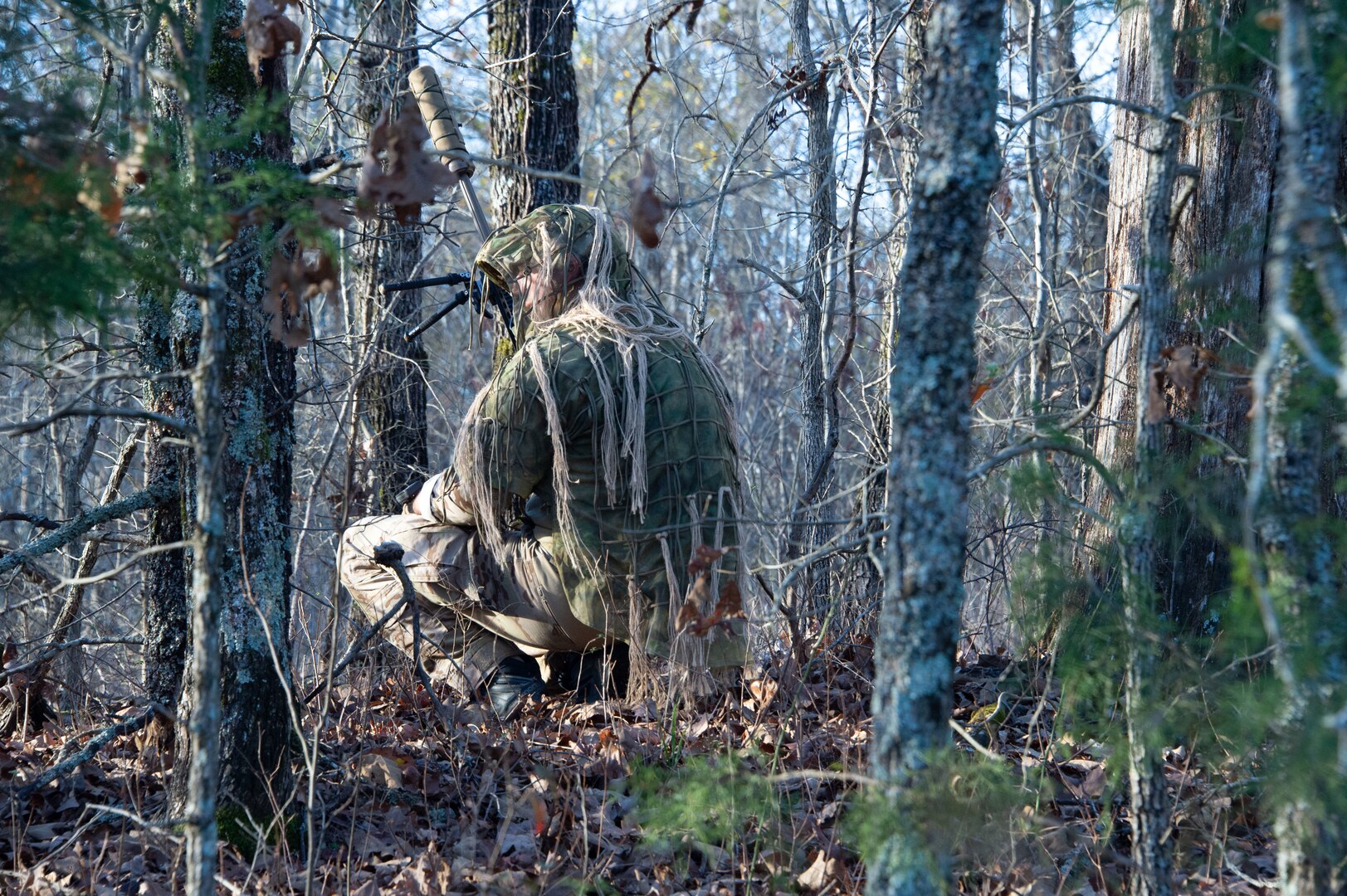 A sniper competitor surveys the area before moving in closer during the stalk portion of the 51st Winston P. Wilson and 31st Armed Forces Skill at Arms Meeting Sniper Championships at the Fort Chaffee Joint Maneuver Training Center Dec. 7, 2021.