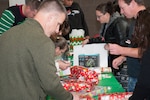 The Colorado National Guard Family Program Office hosts a Santa Shop at the North Colorado Springs Readiness Center, Colorado Springs, Colorado, December 14, 2019. The santa shop allows National Guard families the opportunity pick out donated gifts, participate in holiday crafts and visit with Santa Claus. The Adjutant General of Colorado U.S. Air Force Maj. Gen. Mike Loh, visited the event to speak with families and volunteers as well as wrap a few gifts for National Guard children. (U.S. Army National Guard photo by Staff Sgt. Joseph K VonNida)