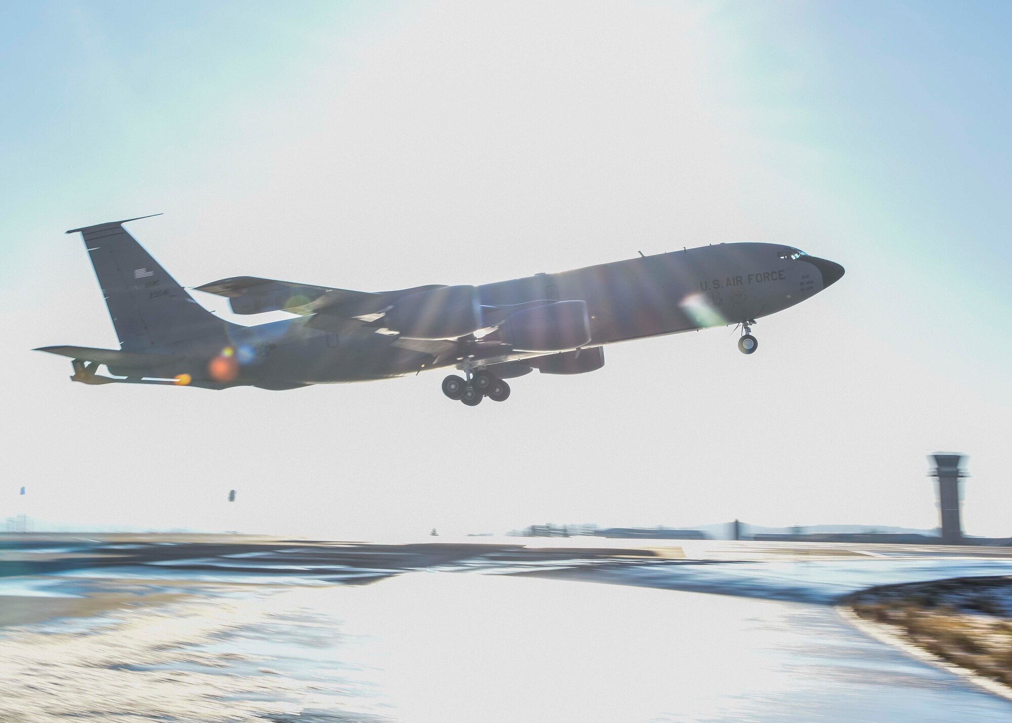 A KC-135 Stratotanker takes off during a large-scale readiness exercise at Fairchild Air Force Base, Washington, Dec. 8, 2021. Multiple crews from Fairchild Air Force Base flew to various locations to train and exercise multi-capable Airmen concepts, such as aircrew Airmen performing routine maintenance tasks on the KC-135. (U.S. Air Force photo by Airman 1st Class Anneliese Kaiser)