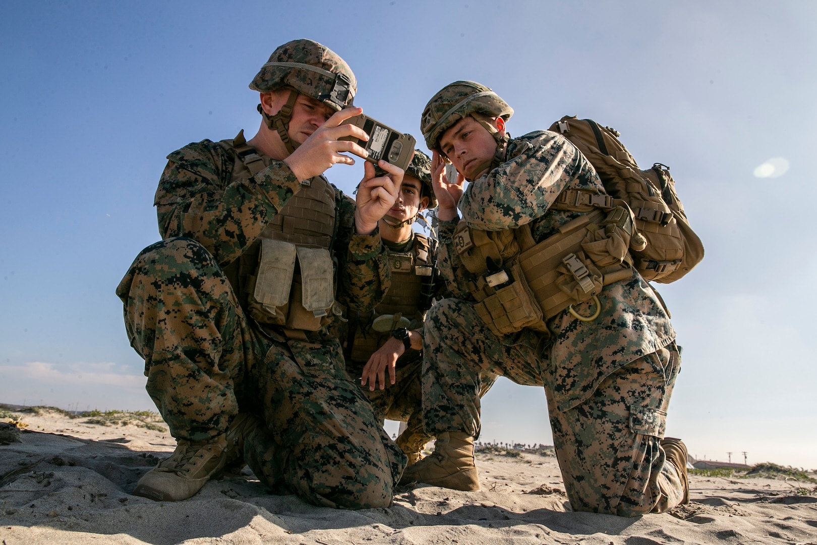 U.S. Marine Corps Sgt. Christopher N. Lupyak, Lance Cpl. Joseph Burns, and Lance Cpl. Nolan Jaros, all combat engineers with the Littoral Engineer Reconnaissance Team, 9th Engineer Support Battalion, 3d Marine Logistics Group, utilize the Android Tactical Assault System to aid in a reconnaissance patrol during a littoral mobility and detection exercise on Camp Pendleton, California, Nov. 18, 2021. The ATAK is a tool that allows Marines to rapidly report critical geospatial information to support intelligence requirements for a given objective. During this exercise, 7th and 9th ESB are refining their skills with emerging Marine Corps technologies in order to facilitate follow-on forces’ littoral mobility from shallow water to the objective.