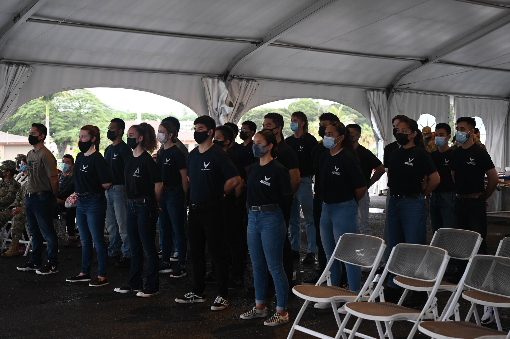 Department of the Air Force recruits stand at ease during a total force enlistment ceremony aboard the Battleship Missouri Memorial at Ford Island, Hawaii, Dec. 6, 2021. Air Force guard, reserve, active-duty and Space Force recruits stated the Oath of Enlistment, being the first enlistment in Hawaii including all Department of the Air Force services. (U.S. Air Force photo by Staff Sgt. Alan Ricker)