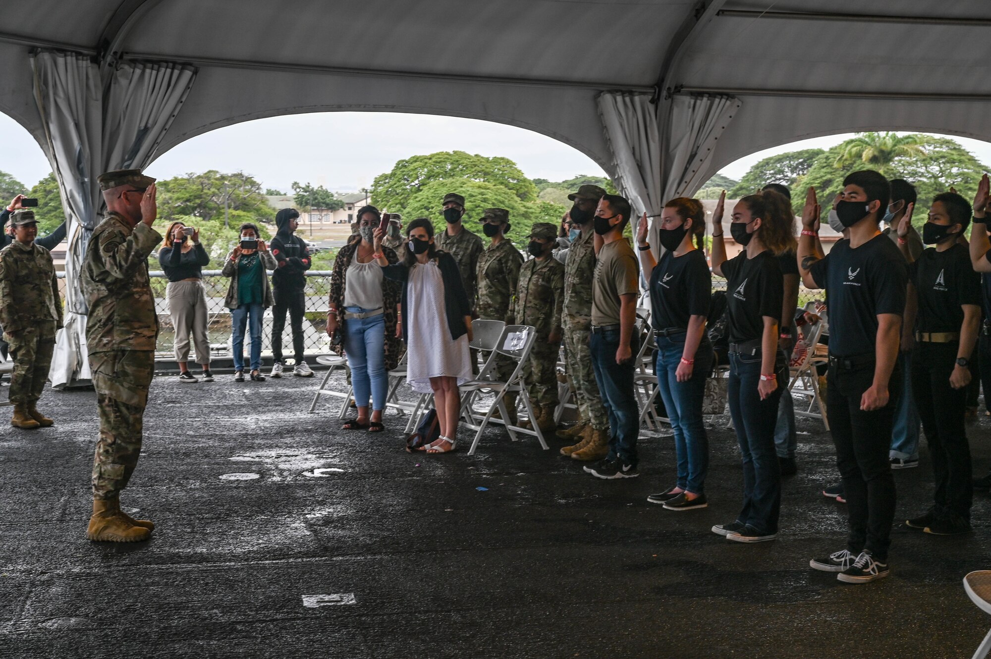 Maj. Gen. Ed Thomas, Commander, Air Force Recruiting Service, administers the Oath of Enlistment during a total force enlistment ceremony aboard the Battleship Missouri Memorial at Ford Island, Hawaii, Dec. 6, 2021. The ceremony was the first in Hawaii to include recruits representing the Air Force guard, reserve, active-duty and Space Force components. (U.S. Air Force photo by Staff Sgt. Alan Ricker)