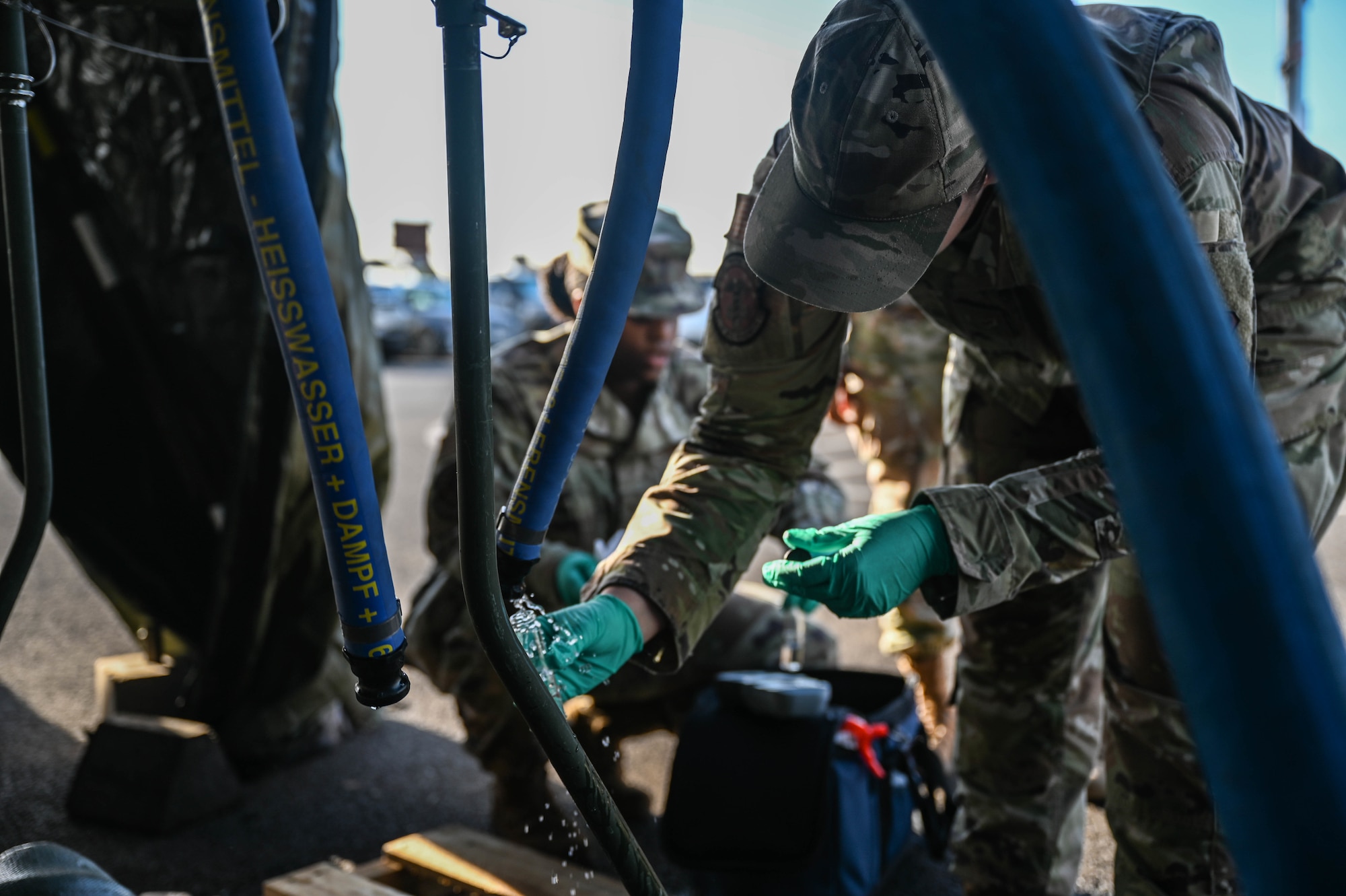 Airman 1st Class Sydni Breitenbach, 15th Operational Medical Readiness Squadron bioenvironmental engineering journeyman, collects a water sample from a 2K Potable Water Module at the Hickam Makai Recreation Center at Joint Base Pearl Harbor-Hickam, Hawaii, Dec. 10, 2021. Bioenvironmental personnel supported the Navy sampling effort by conducting pH tests, free chlorine tests and volatile organic compound screenings at 17 different sites on the Hickam side of JBPHH. (U.S. Air Force photo by Staff Sgt. Alan Ricker)