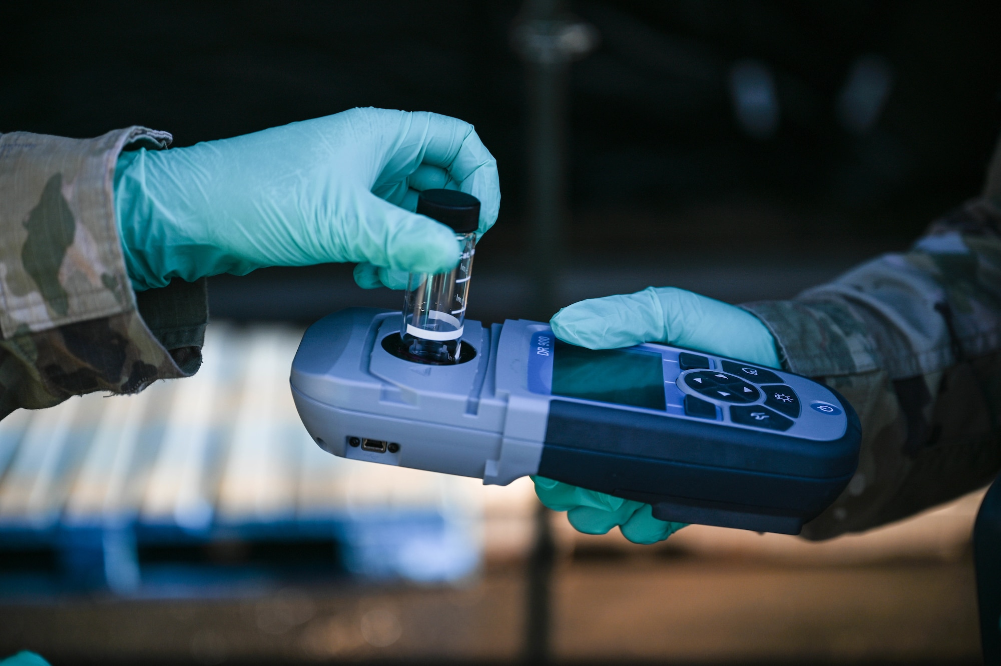 Airman 1st Class Sydni Breitenbach and Senior Airman Christina Burks, 15th Operational Medical Readiness Squadron bioenvironmental engineering journeymen, conduct a free chlorine test of a water sample taken from a 2K Potable Water Module with a multiparameter portable colorimeter at the Hickam Makai Recreation Center at Joint Base Pearl Harbor-Hickam, Hawaii, Dec. 10, 2021. Bioenvironmental Airmen assisted the Navy water sampling effort by screening and providing additional data from 17 different sites on the Hickam side of JBPHH. (U.S. Air Force photo by Staff Sgt. Alan Ricker)