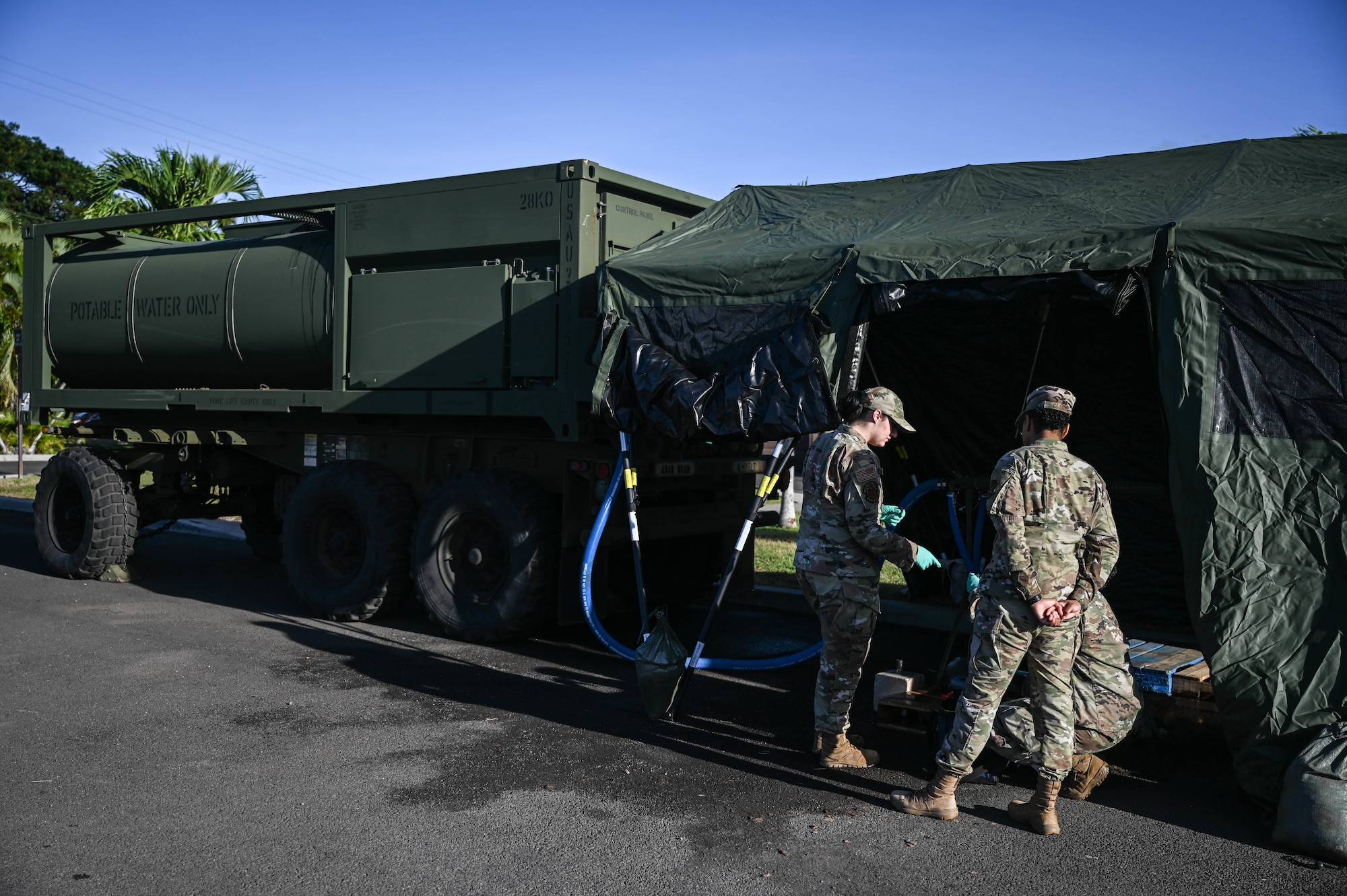 Airman 1st Class Sydni Breitenbach and Senior Airman Christina Burks, 15th Operational Medical Readiness Squadron bioenvironmental engineering journeymen, and Senior Airman Bionca Clarke, 15th OMRS public health technician, screen water samples from a 2K Potable Water Module at the Hickam Makai Recreation Center at Joint Base Pearl Harbor-Hickam, Hawaii, Dec. 10, 2021. In coordination with the Navy’s water sampling effort, the 15th Medical Group’s bioenvironmental team provided supplemental information from water screenings taken from Air Force sites on JBPHH. (U.S. Air Force photo by Staff Sgt. Alan Ricker)