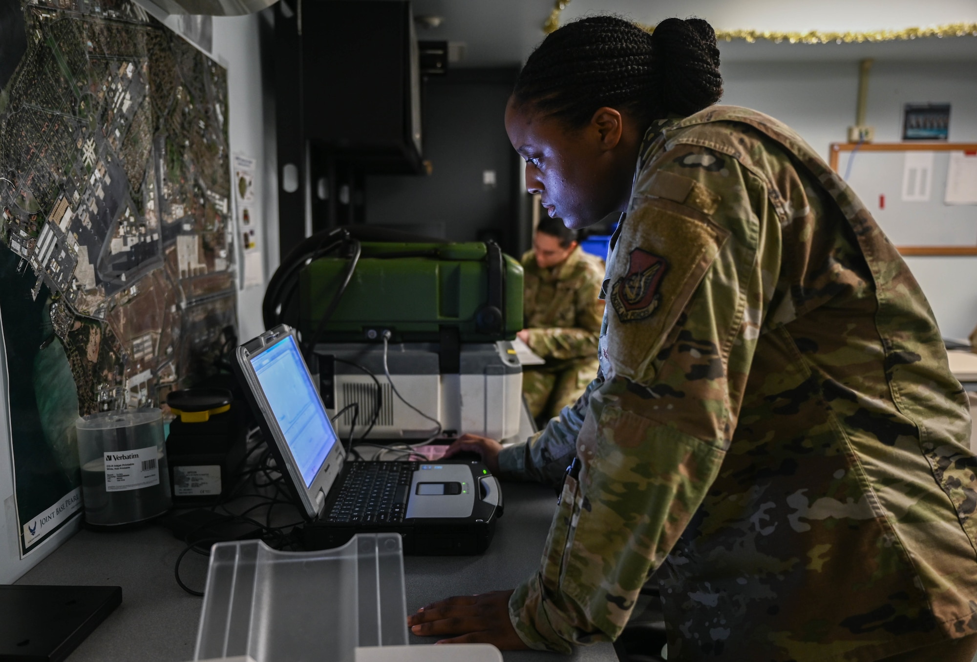 Senior Airman Christina Burks, 15th Operational Medical Readiness Squadron bioenvironmental engineering journeyman, reads water sampling results at the Bioenvironmental Flight laboratory at Joint Base Pearl Harbor-Hickam, Hawaii, Dec. 10, 2021. The chromatograph mass spectrometer is utilized to detect volatile organic compounds in water samples. If VOC is detected, the flight will coordinate rigorous testing with Navy personnel. (U.S. Air Force photo by Staff Sgt. Alan Ricker)