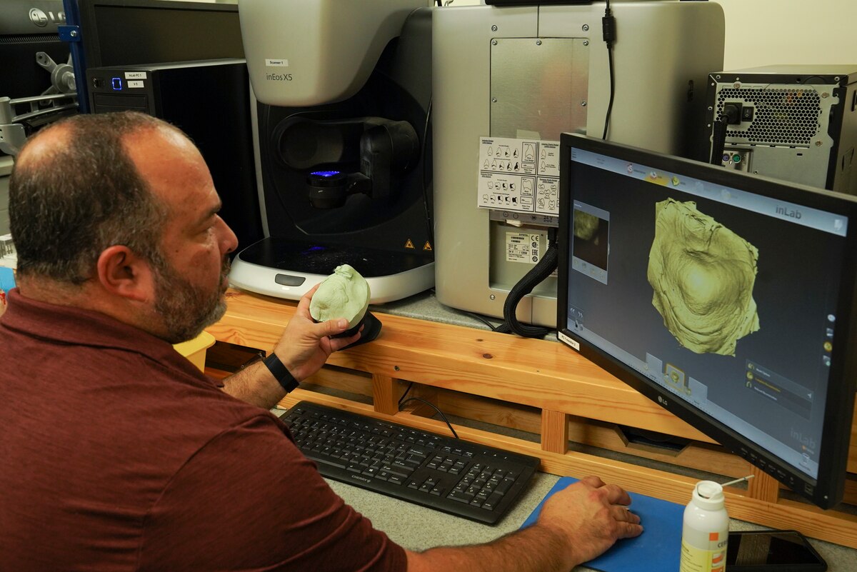 Stephen Deries, 81st Dental Squadron dental lab technician, demonstrates the technology used to make dentures inside Keesler Medical Center at Keesler Air Force Base, Miss., Oct. 4, 2021. In a partnership with the 81st Medical Diagnostics and Therapeutic Squadron’s radiation and oncology flight, Deries discovered a way to create custom radiation boluses for cancer patients receiving radiation therapy.
