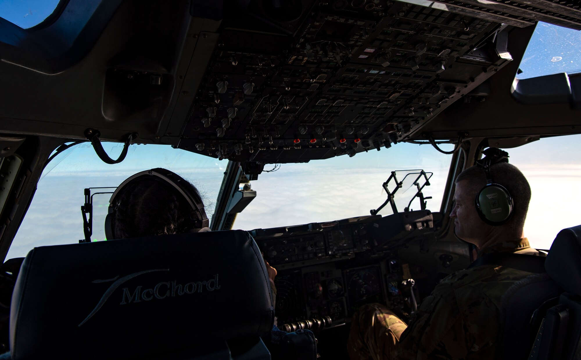 U.S. Air Force 1st Lt. Erica Drakes, 4th Airlift Squadron pilot, left, and U.S. Air Force Col. Brian Collins, 62nd Airlift Wing vice commander, fly a C-17 Globemaster III carrying Airmen assigned to Joint Base Lewis-McChord, Washington; Joint Base McGuire-Dix-Lakehurst, New Jersey; and Dover Air Force Base, Delaware, deploying to the 816th Expeditionary Airlift Squadron at Al Udeid Air Base, Qatar, Nov. 28, 2021. Drakes remained in Qatar as a member of the 816th EAS, while Collins was a part of the air crew returning those who had finished their deployment home. (U.S. Air Force photo by Staff Sgt. Tryphena Mayhugh)