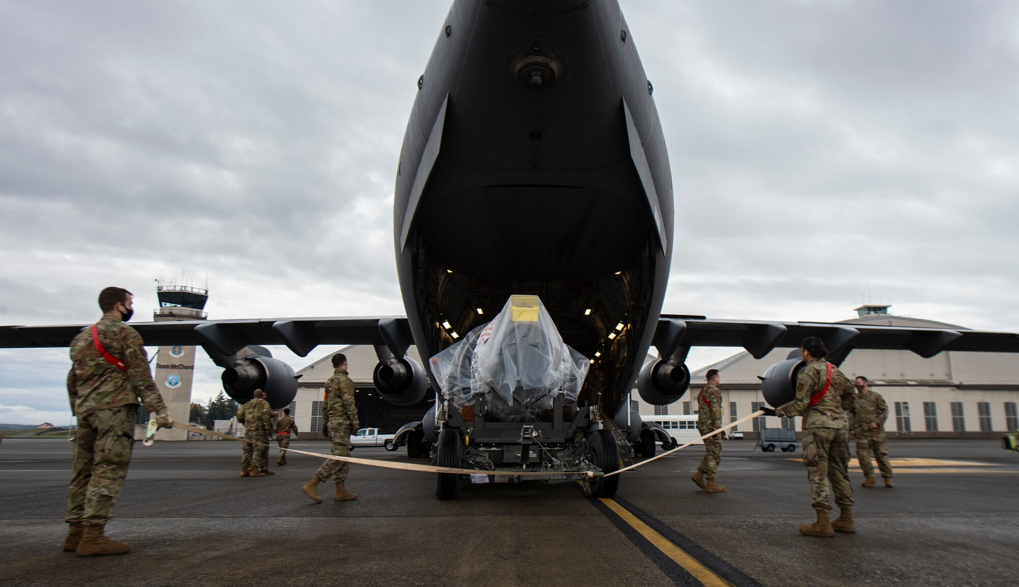 U.S. Airmen assigned to the 62nd Aerial Port Squadron load a C-17 Globemaster III jet engine onto a C-17 at Joint Base Lewis-McChord, Washington, Nov. 27, 2021. The jet engine was being delivered to Joint Base McGuire-Dix-Lakehurst, New Jersey, during the 816th Expeditionary Airlift Squadron deployment swap out at Al Udeid Air Base, Qatar. (U.S. Air Force photo by Staff Sgt. Tryphena Mayhugh)