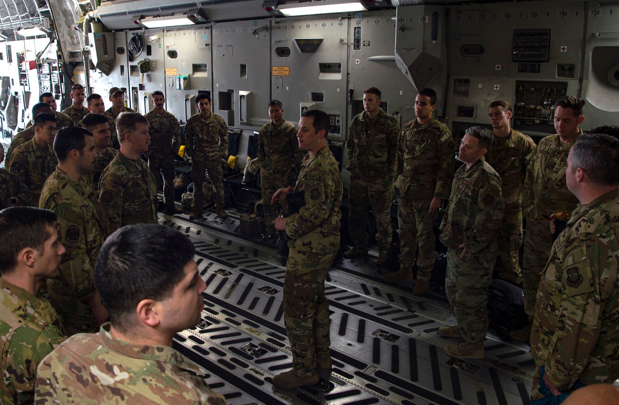 U.S. Air Force Lt. Col. Patrick McLaughlin, 816th Expeditionary Airlift Squadron commander, greets incoming deploying Airman on a C-17 Globemaster III at Al Udeid Air Base, Qatar, Nov. 29, 2021. Airmen assigned to Joint Base Lewis-McChord, Washington, and other Air Mobility Command C-17 bases periodically switch outgoing deploying Airmen for incoming ones in what is known as the EAS swap out. (U.S. Air Force photo by Staff Sgt. Tryphena Mayhugh)