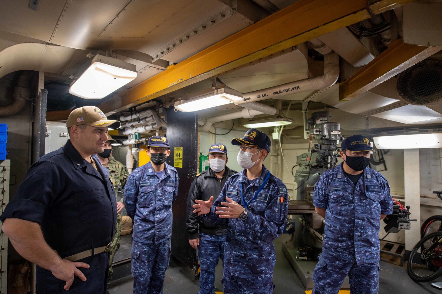 Cmdr. Bryan Gallant, the executive officer aboard the forward-deployed amphibious dock landing ship USS Rushmore (LSD 47), discusses the ship’s capabilities with Japan Maritime Self-Defense Force Cmdr. Hisanari Saito during a tour of the ship. Rushmore, part of Amphibious Squadron 11, is operating in the U.S. 7th Fleet area of responsibility to enhance interoperability with allies and partners and serve as a ready response force to defend peace and stability in the Indo-Pacific region.