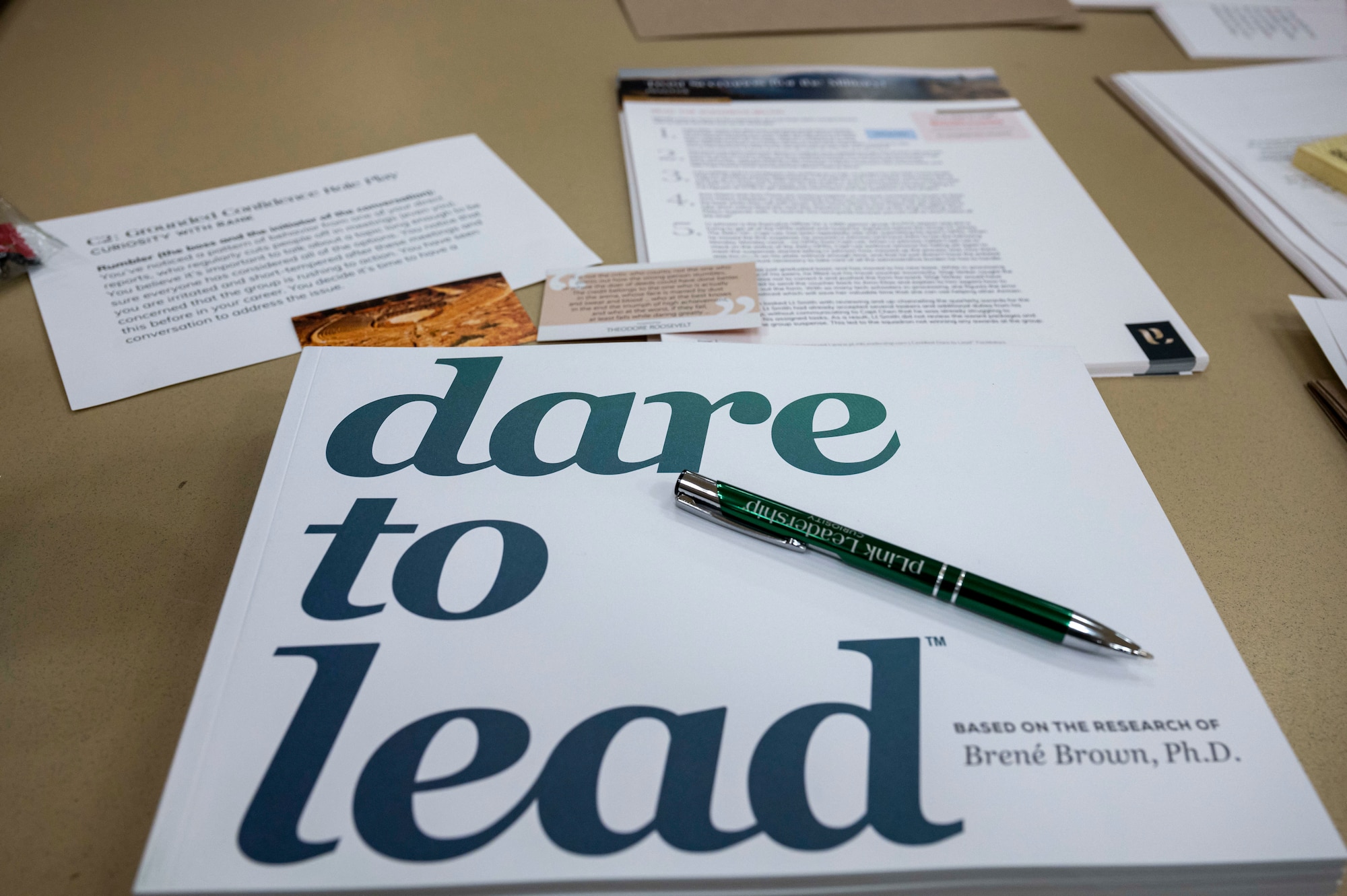A dare to lead packet on a table.