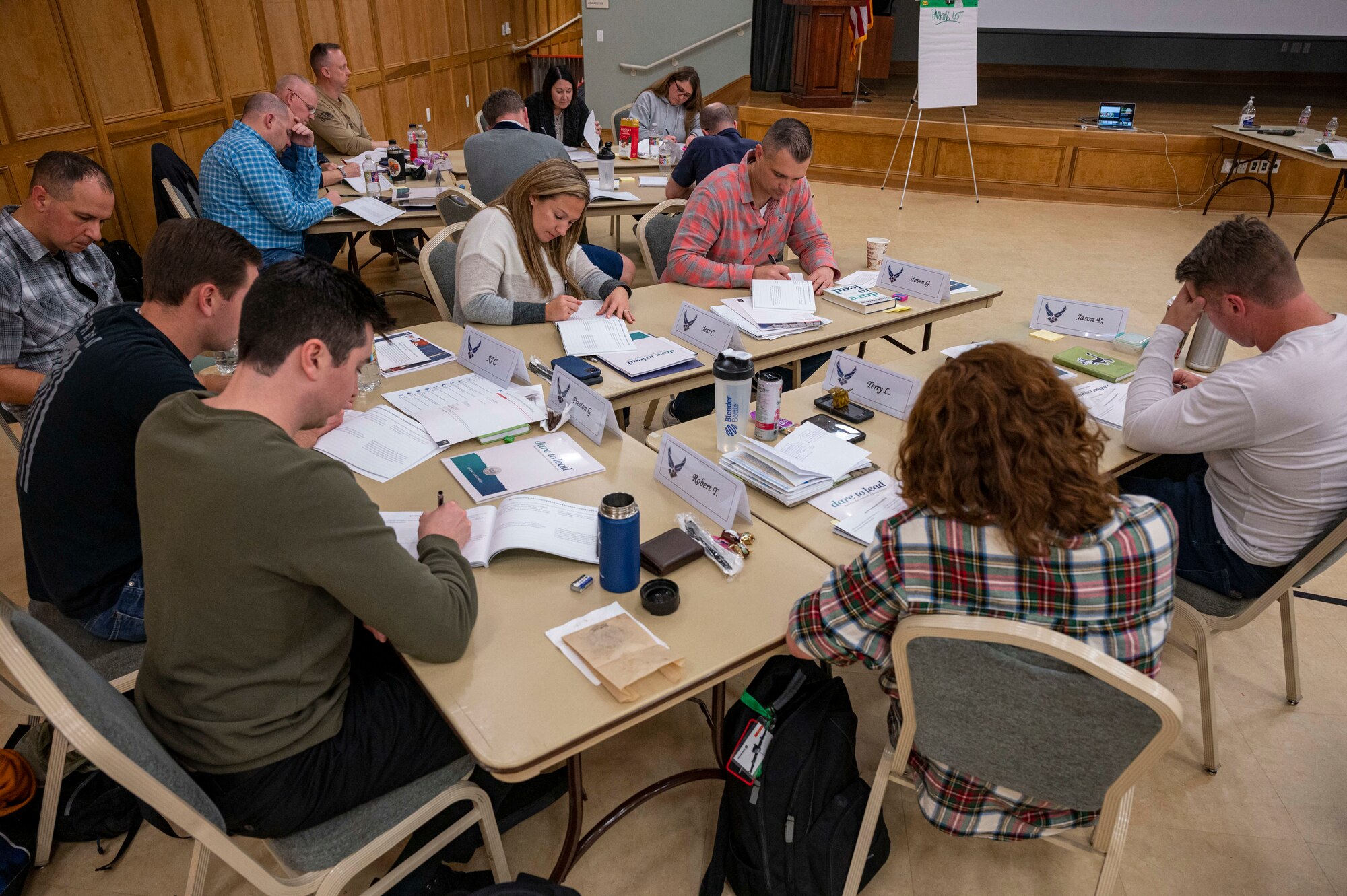 People at a table work on a group assignment.