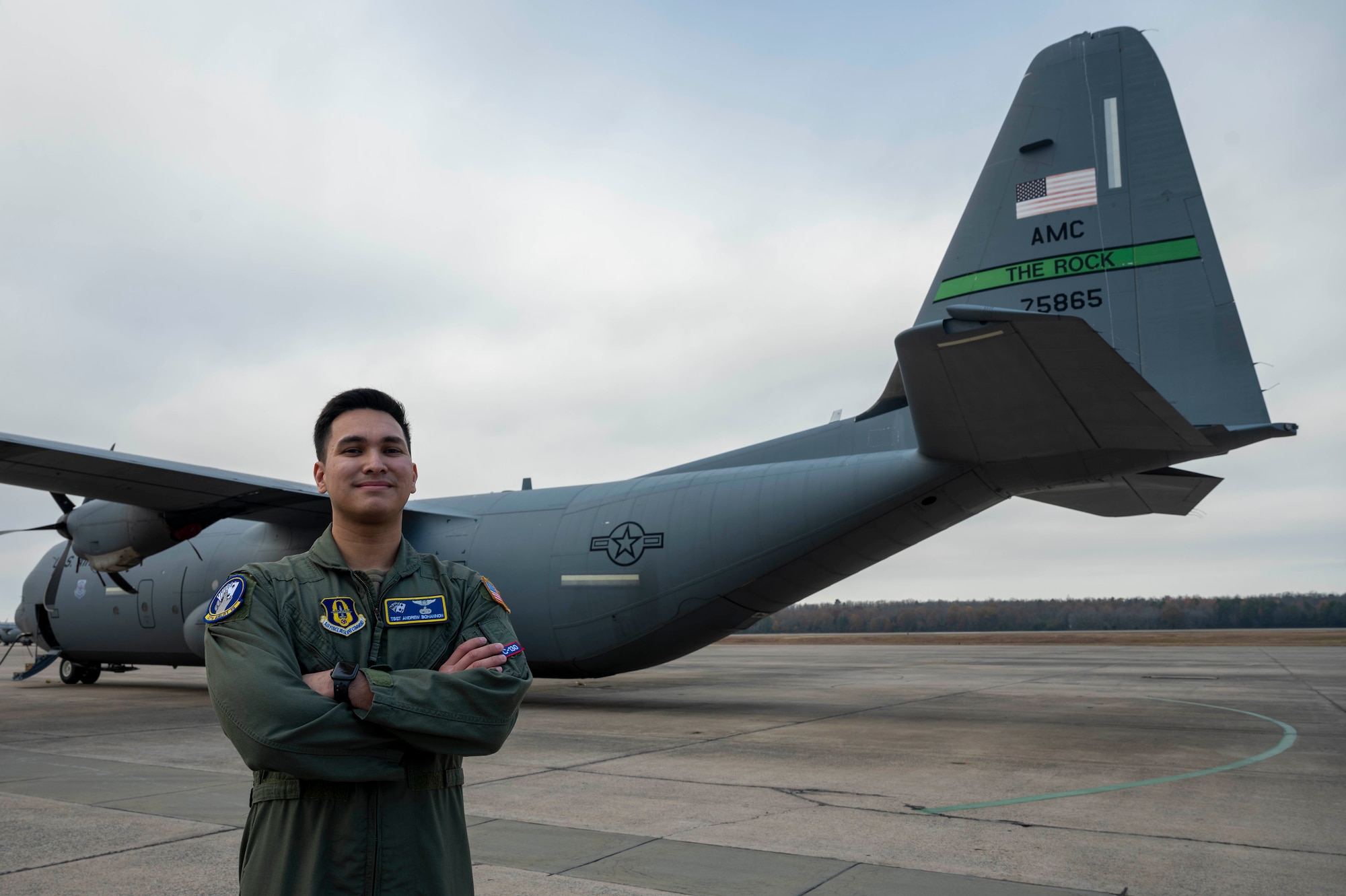 An Airman stands in front of a C-130J Super Hercules.
