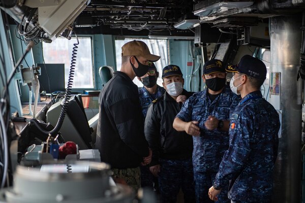 Lt. Cmdr. Tyler Maness, assigned to Amphibious Squadron (PHIBRON) 11, conducts a tour of the pilot house aboard the forward-deployed amphibious assault ship USS America (LHA 6) for allies from the Japan Maritime Self-Defense Force. PHIBRON 11, the Navy’s only forward-deployed amphibious squadron, is operating in the U.S. 7th Fleet area of responsibility to enhance interoperability with allies and partners and serve as a ready response force to defend peace and stability in the Indo-Pacific region.