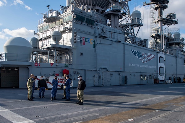 Lt. Cmdr. Tyler Maness, assigned to Amphibious Squadron (PHIBRON) 11, conducts a tour of the flight deck aboard the forward-deployed amphibious assault ship USS America (LHA 6) for allies from the Japan Maritime Self-Defense Force. PHIBRON 11, the Navy’s only forward-deployed amphibious squadron, is operating in the U.S. 7th Fleet area of responsibility to enhance interoperability with allies and partners and serve as a ready response force to defend peace and stability in the Indo-Pacific region.