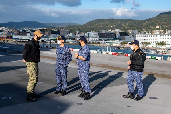 Lt. Cmdr. Tyler Maness, assigned to Amphibious Squadron (PHIBRON) 11, conducts a tour of the flight deck aboard the forward-deployed amphibious assault ship USS America (LHA 6) for allies from the Japan Maritime Self-Defense Force. PHIBRON 11, the Navy’s only forward-deployed amphibious squadron, is operating in the U.S. 7th Fleet area of responsibility to enhance interoperability with allies and partners and serve as a ready response force to defend peace and stability in the Indo-Pacific region.