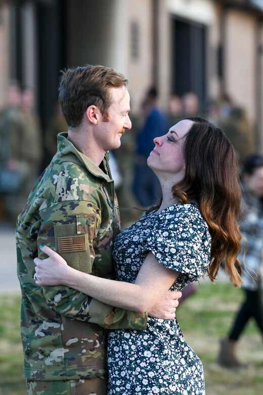 An Airman greets his wife upon returning from deployment.