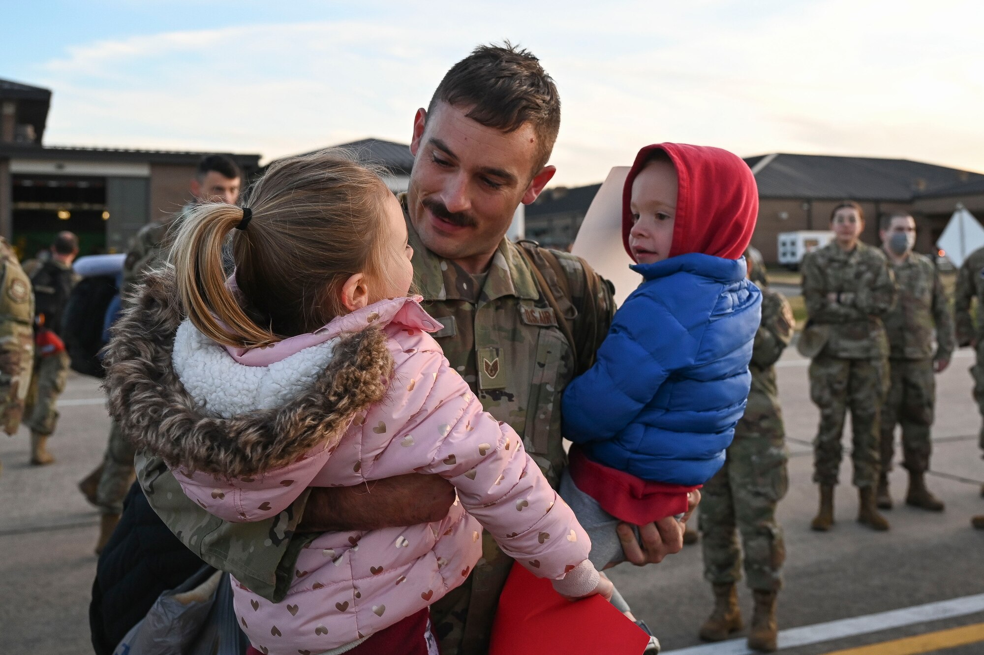An Airman greets his children upon returning from deployment.