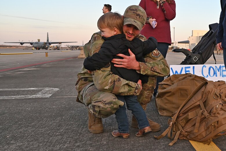 An Airmen greets his son upon returning from deployment.