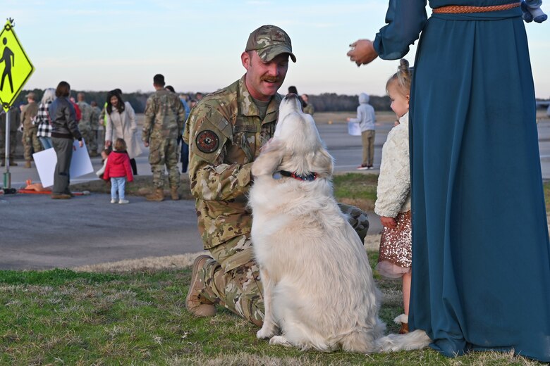 An Airmen greets his dog upon returning from deployment.