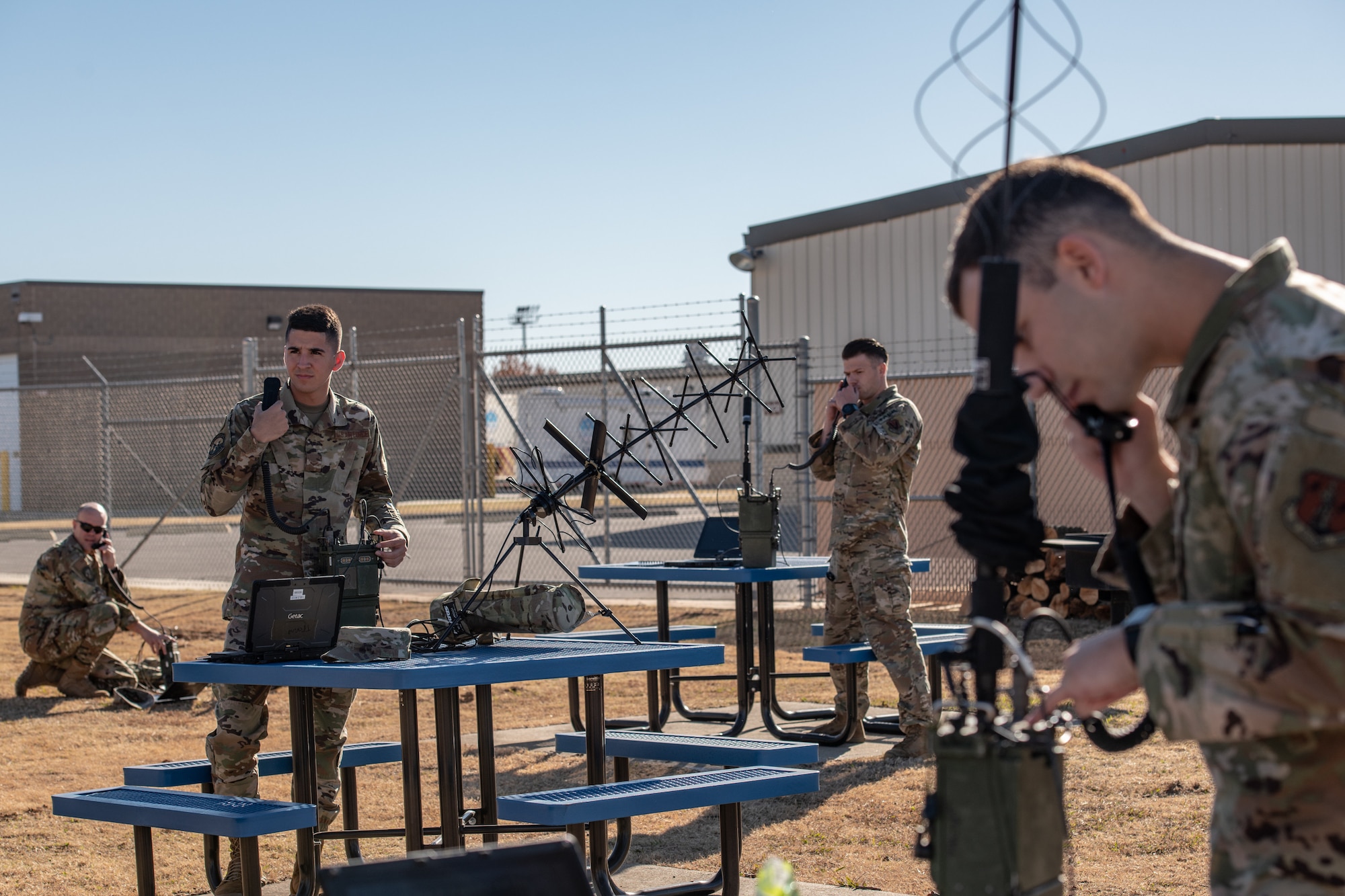 group of Airmen talk into radios