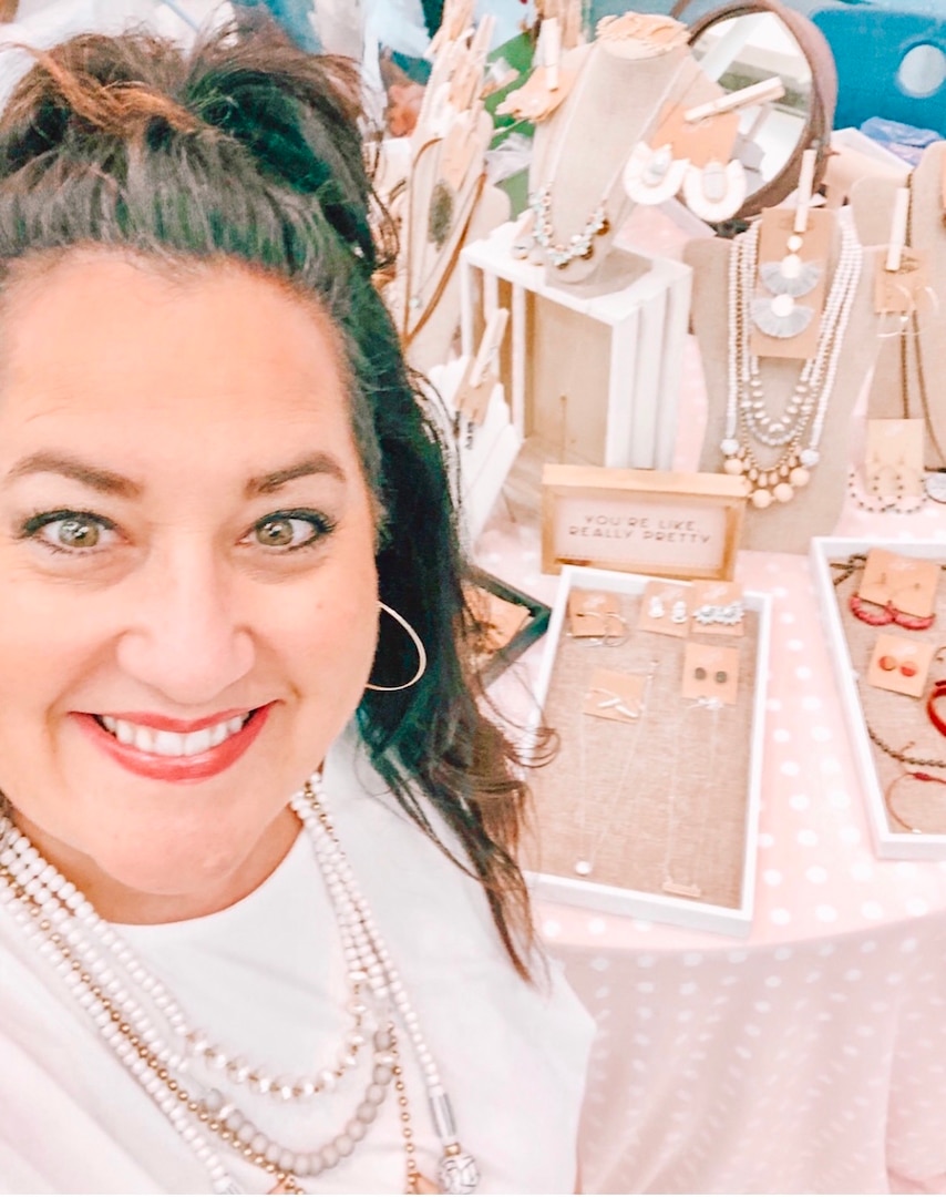 Paulette Fryar wears pieces of her jewelry from her business as an independent distributor. Fyar has been in the business for four years and has been able to continue working as she has relocated throughout the country with her spouse.