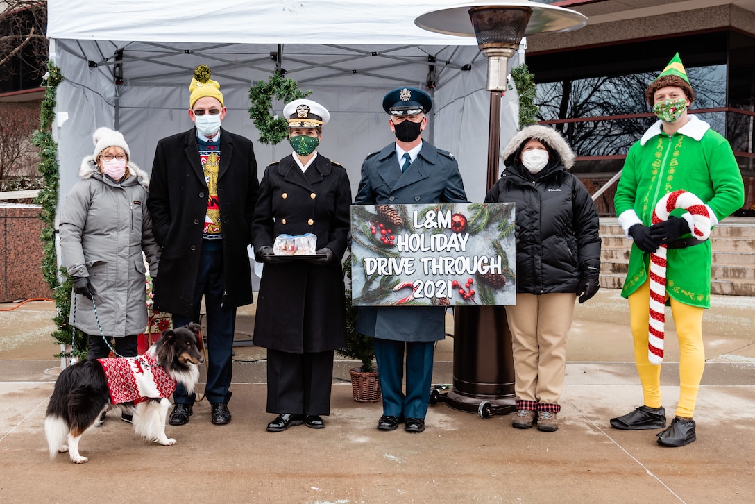 A group of people dressed in holiday attire posing for a photo.