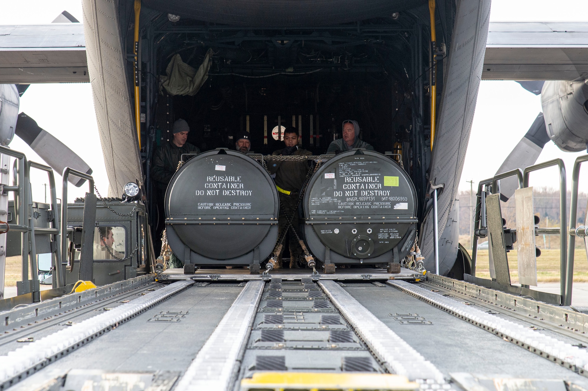 Airmen from the 436th Aerial Port Squadron push pallets onto a cargo loader during the unloading of a Polish air force C-130E Hercules Dec. 7, 2021, at Dover Air Force Base, Delaware, as part of a foreign military sales mission. The United States and Poland have enjoyed decades-long warm bilateral relations. Poland is a stalwart NATO ally, and both the U.S. and Poland remain committed to the regional security and prosperity of Europe. Due to its strategic location, Dover AFB supports approximately $3.5 billion worth of foreign military sales annually. (U.S. Air Force photo by Roland Balik)