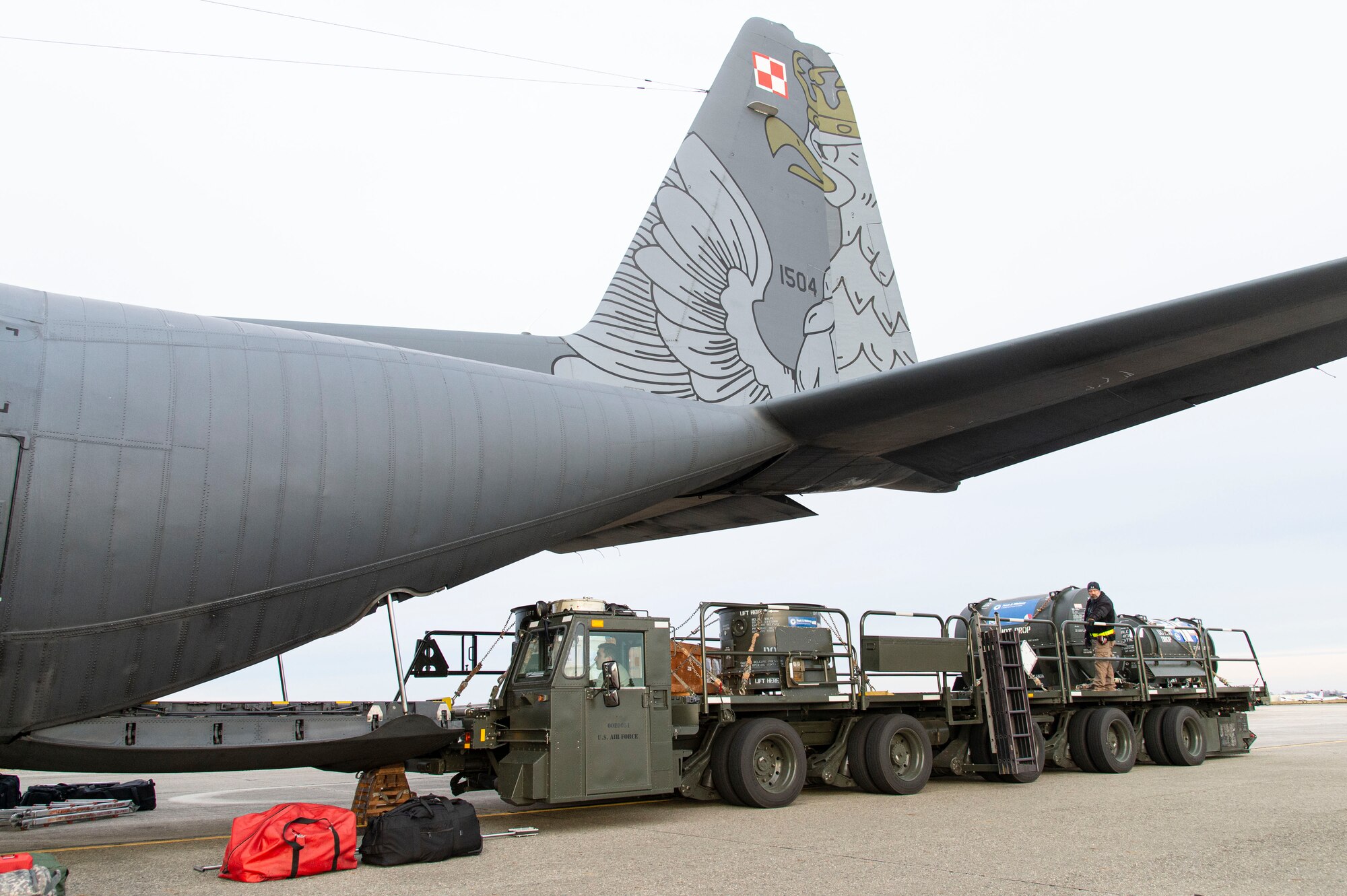 Ramp services personnel from the 436th Aerial Port Squadron secure pallets on a cargo loader after unloading a Polish air force C-130E Hercules Dec. 7, 2021, at Dover Air Force Base, Delaware, as part of a foreign military sales mission. The United States and Poland have enjoyed decades-long warm bilateral relations. Poland is a stalwart NATO ally, and both the U.S. and Poland remain committed to the regional security and prosperity of Europe. Due to its strategic location, Dover AFB supports approximately $3.5 billion worth of foreign military sales annually. (U.S. Air Force photo by Roland Balik)