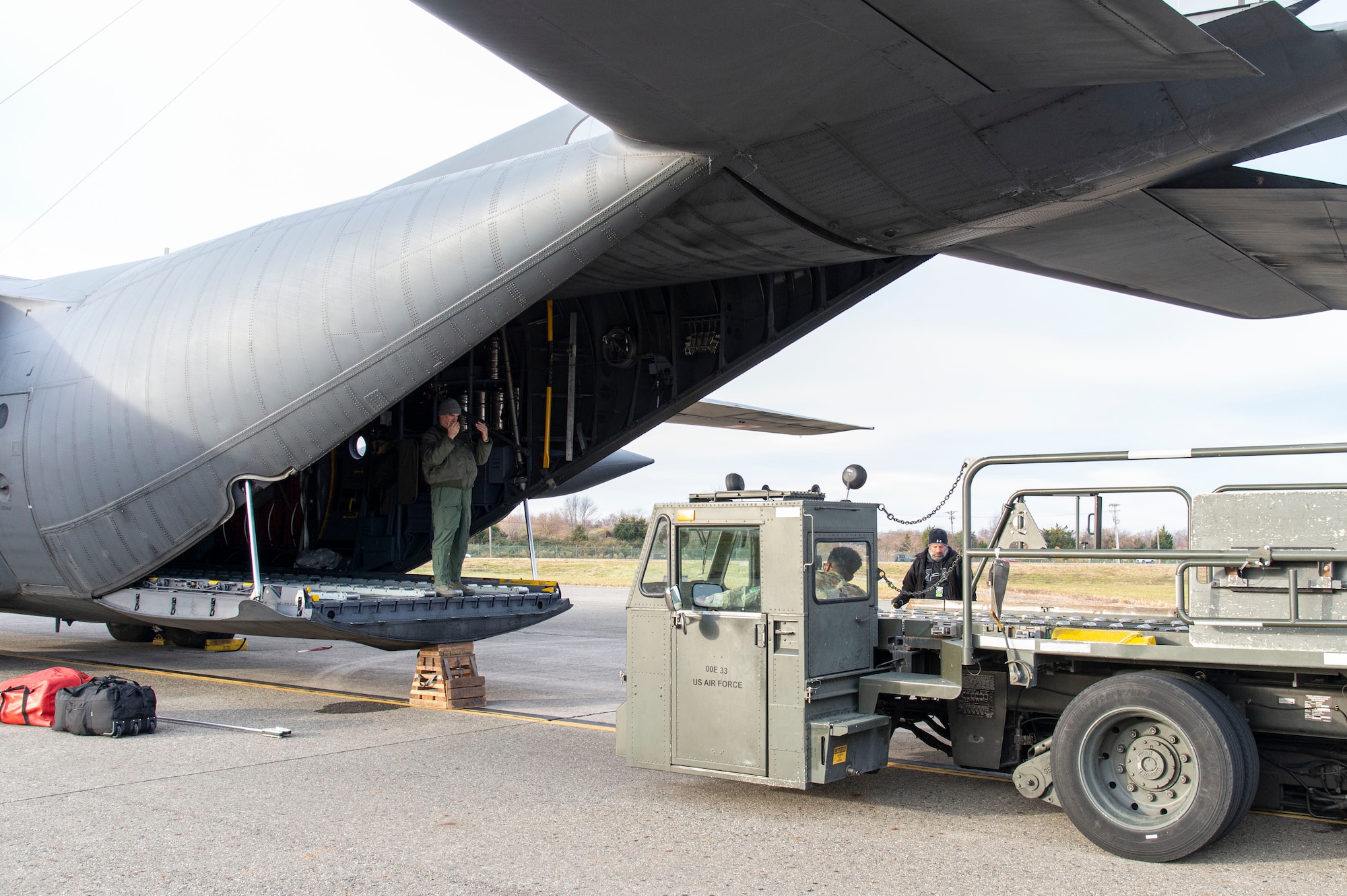 A Polish air force loadmaster marshals a cargo loader driven by a 436th Aerial Port Squadron ramp services load team member Dec. 7, 2021, at Dover Air Force Base, Delaware, during a foreign military sales mission. The United States and Poland have enjoyed decades-long warm bilateral relations. Poland is a stalwart NATO ally, and both the U.S. and Poland remain committed to the regional security and prosperity of Europe. Due to its strategic location, Dover AFB supports approximately $3.5 billion worth of foreign military sales annually. (U.S. Air Force photo by Roland Balik)