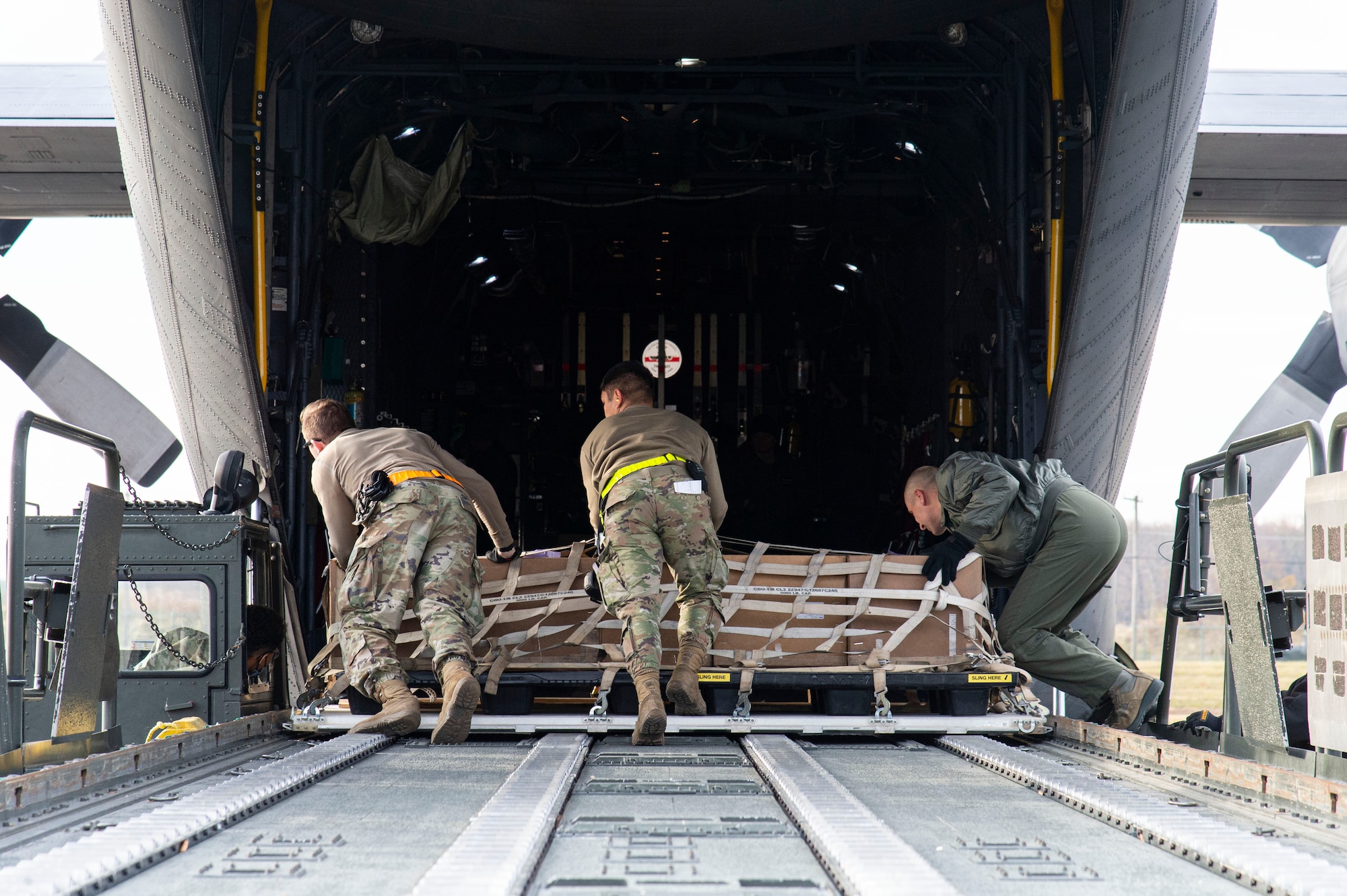 Ramp services personnel from the 436th Aerial Port Squadron, along with a Polish air force loadmaster, load a pallet onto a Polish air force C-130E Hercules Dec. 7, 2021, at Dover Air Force Base, Delaware, during a foreign military sales mission. The United States and Poland have enjoyed decades-long warm bilateral relations. Poland is a stalwart NATO ally, with which the U.S. partners closely on NATO capabilities, counterterrorism, nonproliferation, missile defense and regional cooperation in Central and Eastern Europe. Due to its strategic location, Dover AFB supports approximately $3.5 billion worth of foreign military sales annually. (U.S. Air Force photo by Roland Balik)