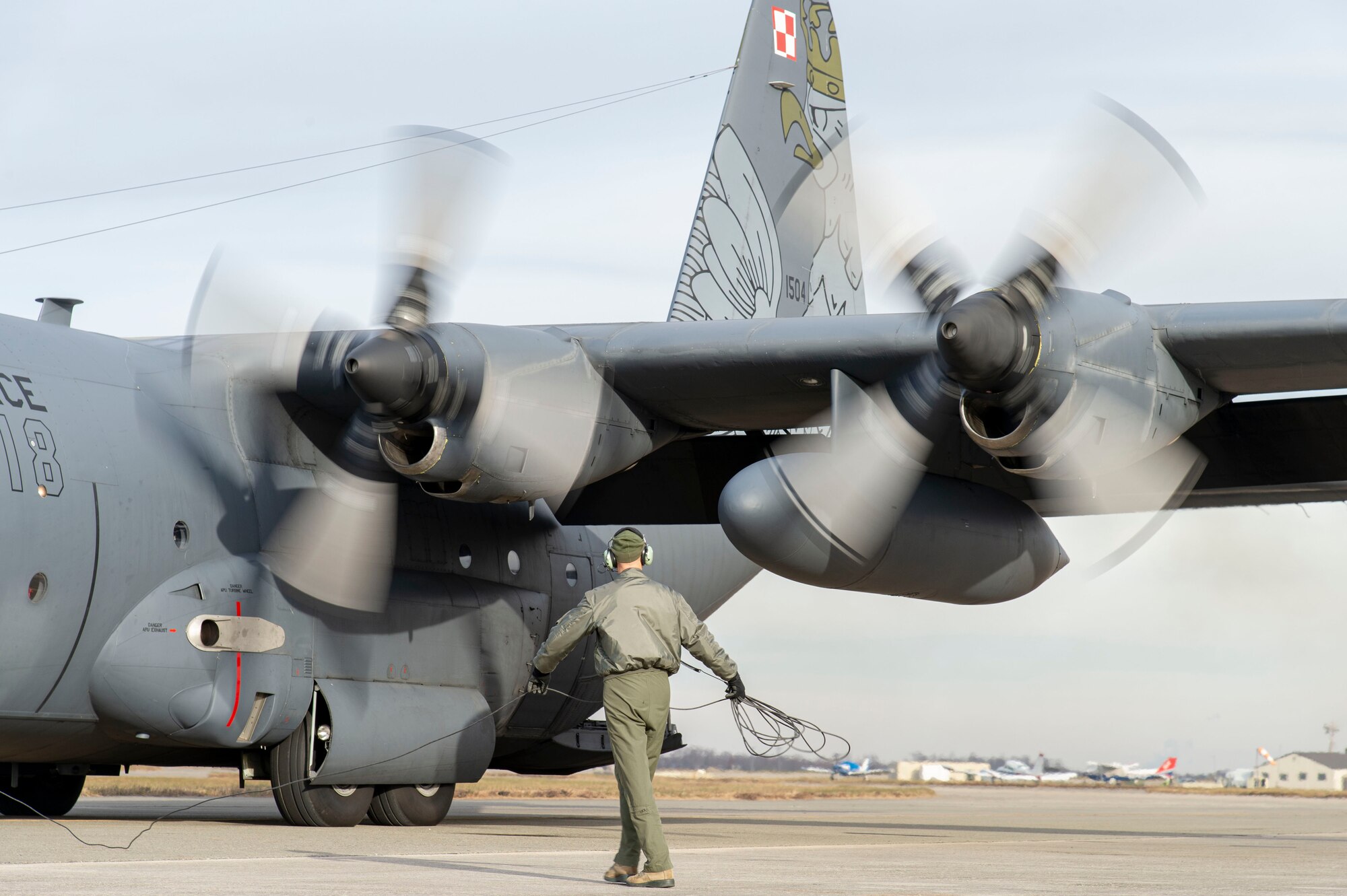 A Polish air force C-130E Hercules starts its engines following a foreign military sales mission Dec. 7, 2021, at Dover Air Force Base, Delaware. The United States and Poland have enjoyed decades-long warm bilateral relations. Poland is a stalwart NATO ally, and both the U.S. and Poland remain committed to the regional security and prosperity of Europe. Due to its strategic location, Dover AFB supports approximately $3.5 billion worth of foreign military sales annually. (U.S. Air Force photo by Roland Balik)