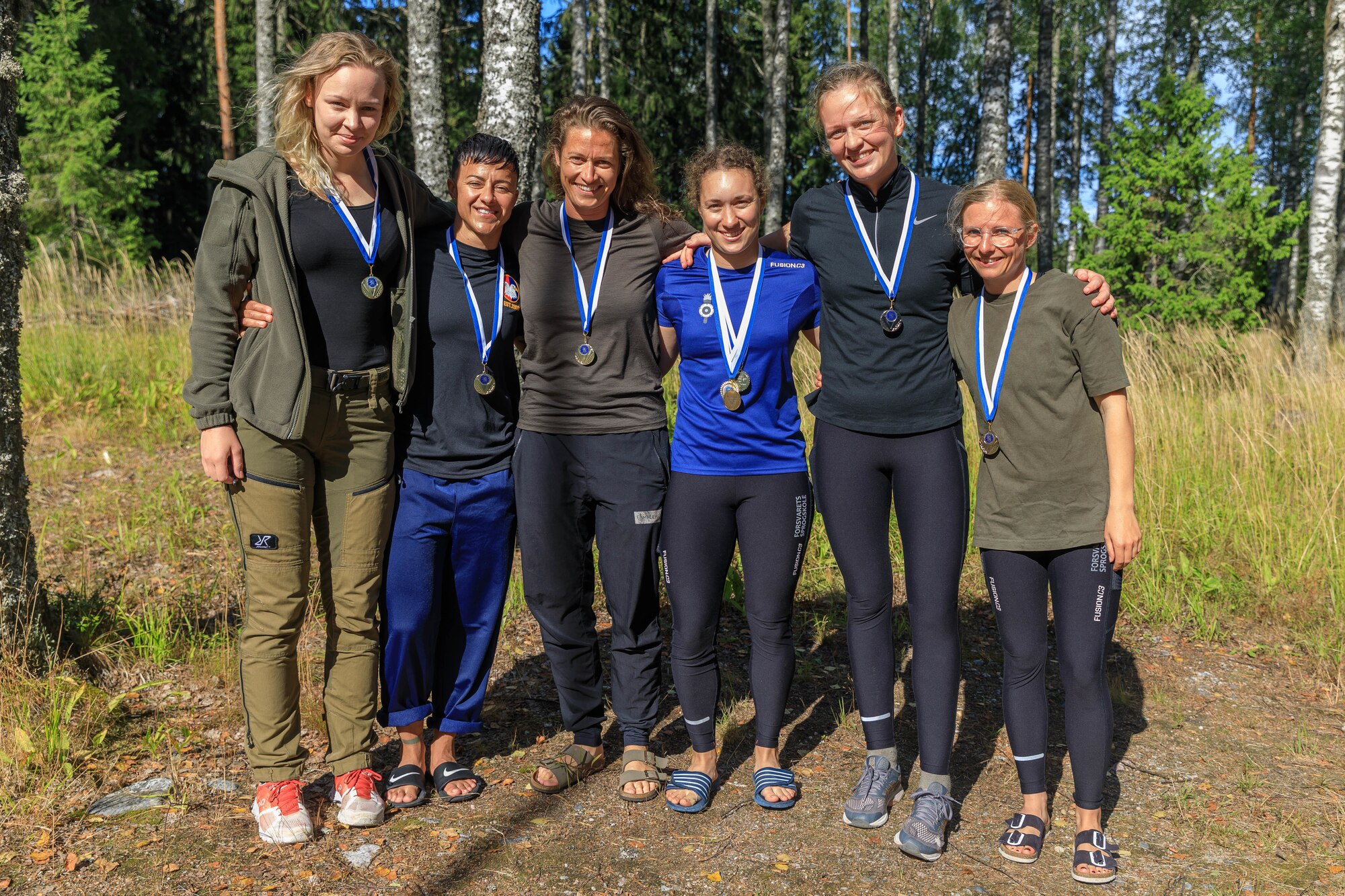 Female competitors pose with their medals earned during the Interallied Confederation of Reserve Officers military competition in Lahti, Finland on August 1st. The CIOR MILCOMP is an annual competition among NATO and Partnership for Peace nations. This competition test reserve service members from allied nations on several core disciplines in teams of three.