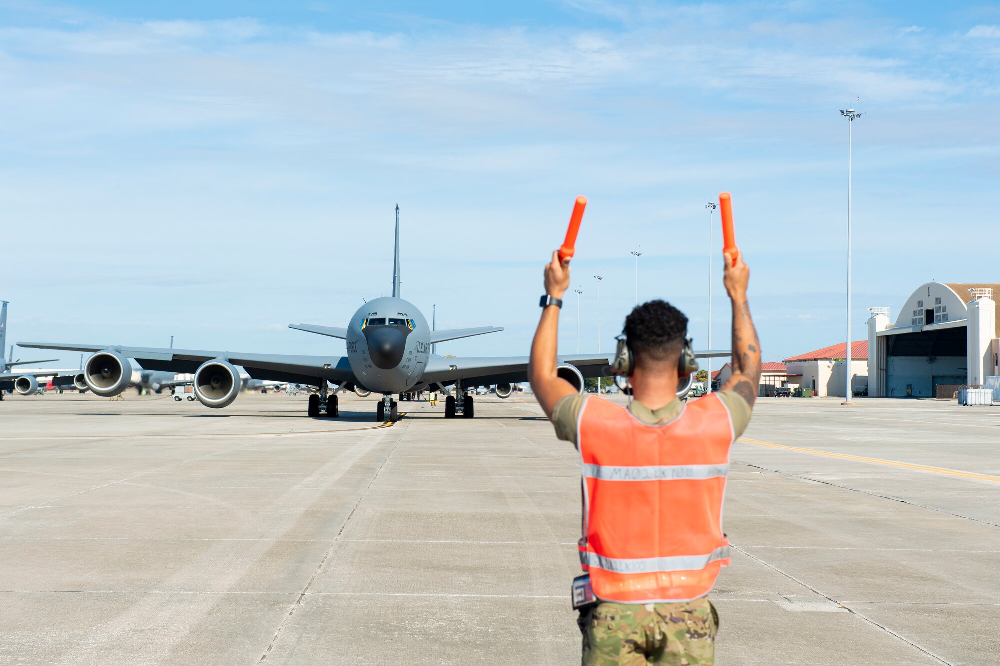 An Airman with the 6th Aircraft Maintenance Squadron marshals a KC-135 Stratotanker aircraft assigned to the 50th Air Refueling Squadron at MacDill Air Force Base, Florida, Dec. 8, 2021.