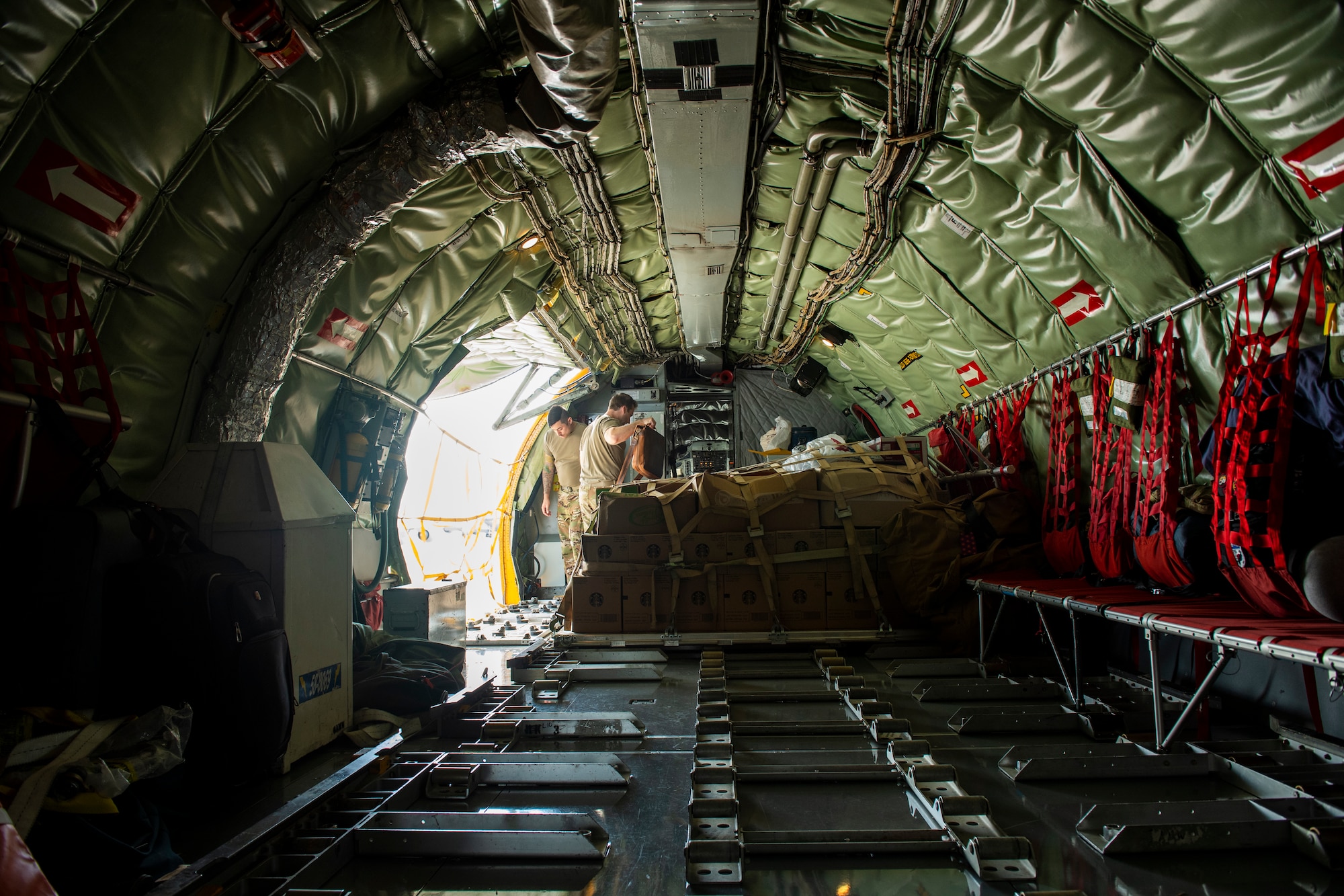 Airmen on-board a KC-135 Stratotanker aircraft from the 50th Air Refueling Squadron secure a cargo load at MacDill Air Force Base, Florida, Dec. 8, 2021.