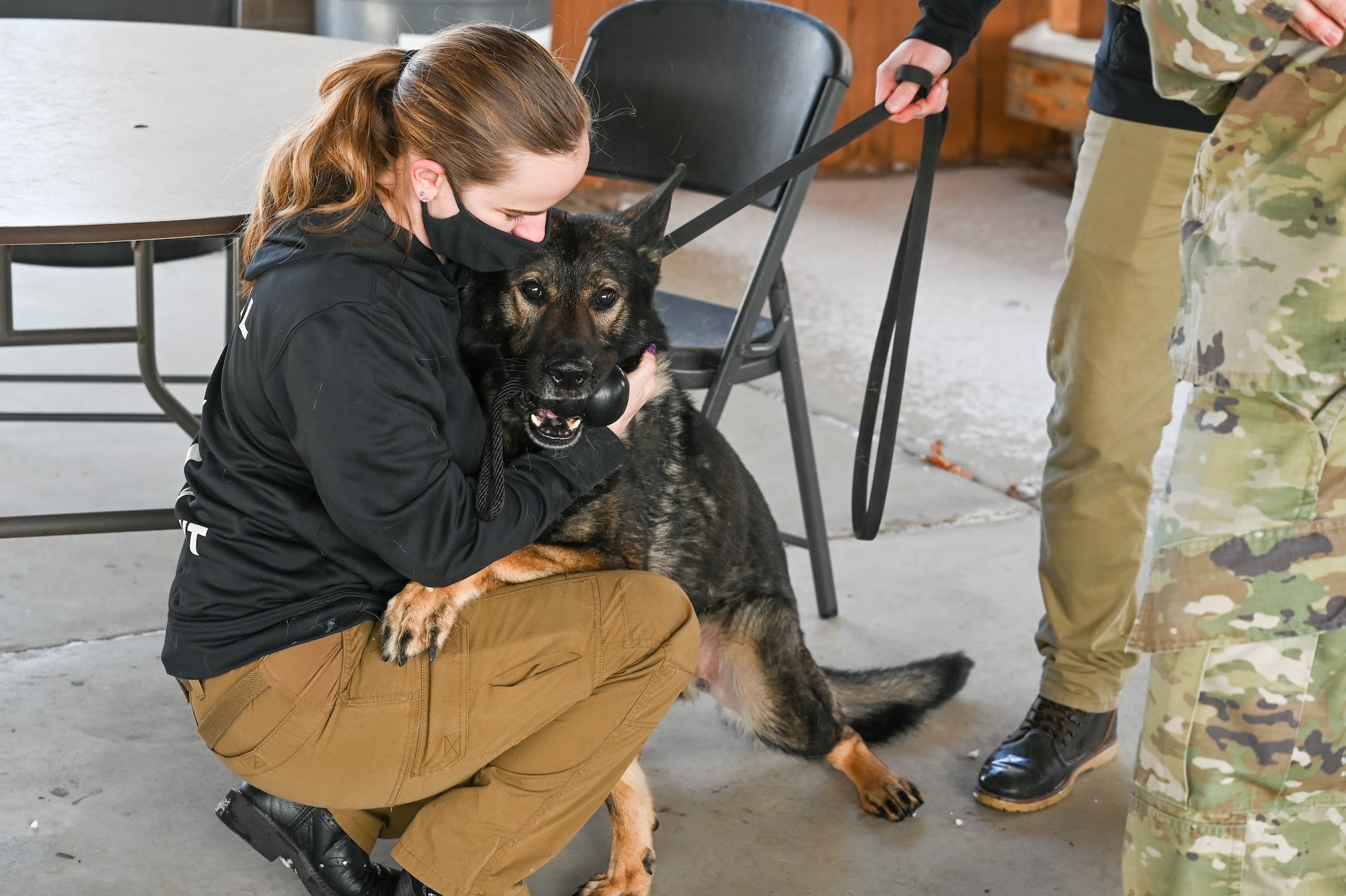 Staff Sgt. Michelle Schrek, 75th Security Forces Squadron, hugs military working dog Jimo during his retirement celebration Dec. 10, 2021, at Hill Air Force Base, Utah. MWD Jimo retired honorably after serving six years with the 75th SFS at Hill. (U.S. Air Force photo by Cynthia Griggs)