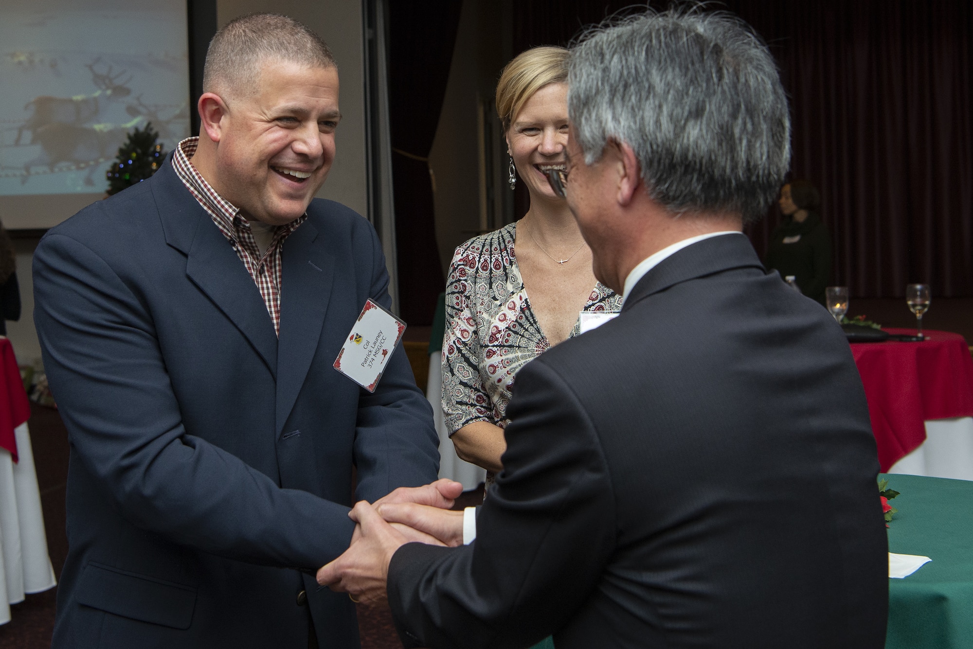 Col. Patrick Launey, 374th Mission Support Group commander, left, bids farewell to Yoshinori Wada, Yokota Defense Office chief, at the end of the 374th AW Holiday Social at the Yokota Officers Club at Yokota Air Base, Japan, Dec. 11, 2021. The event was an opportunity for wing leadership and Japanese partners from the Japan Air Self Defense Forces, Japan America Air Force Goodwill Association, friendship clubs, and Government of Japan, to celebrate the holiday season together. Attendees were able to strengthen their relationship while enjoying live music performed by the Yokota High School and a children’s ballet dance. (U.S. Air Force photo by Tech. Sgt. Christopher Hubenthal)