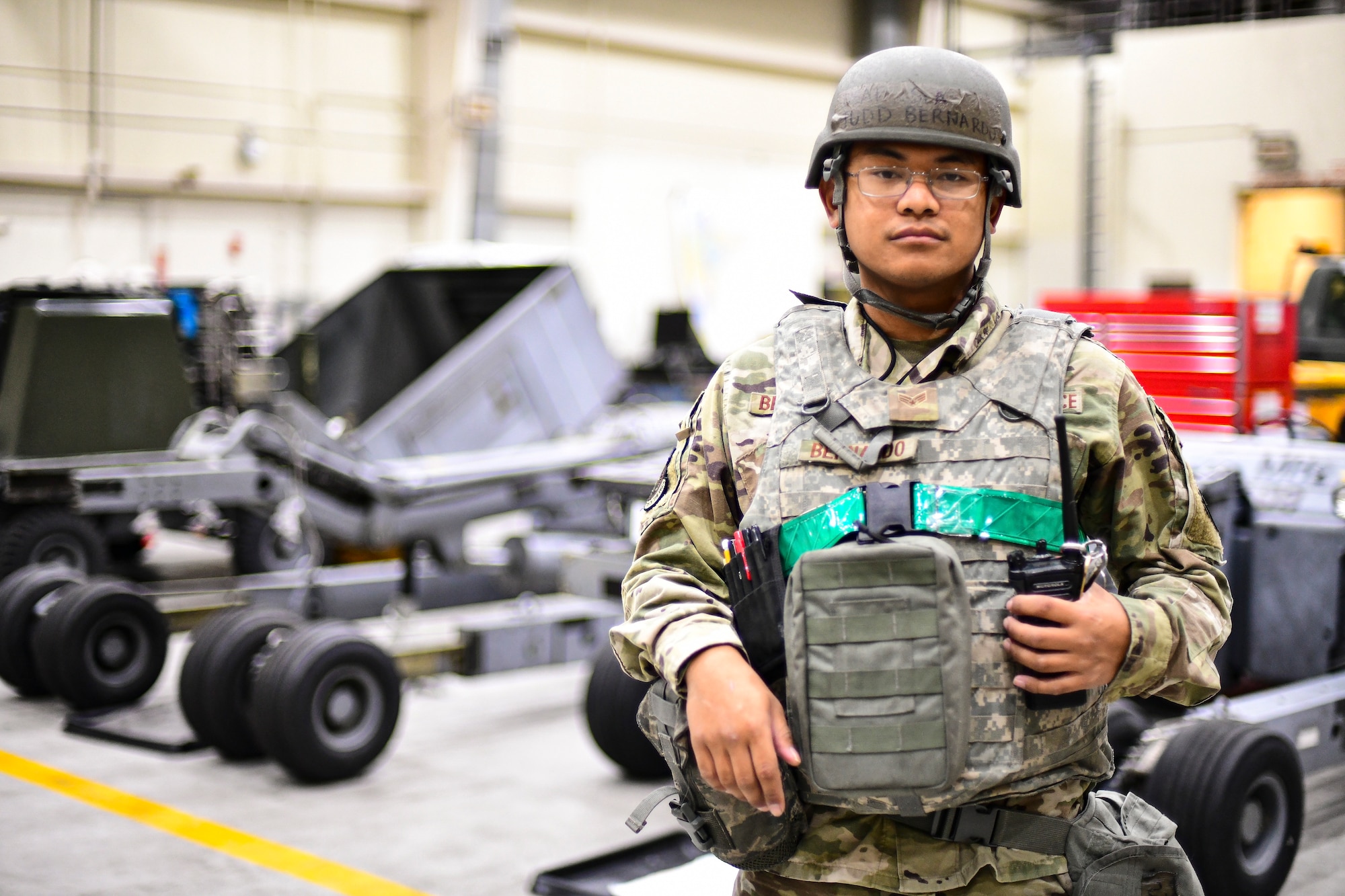 An Airman stands in a hangar.