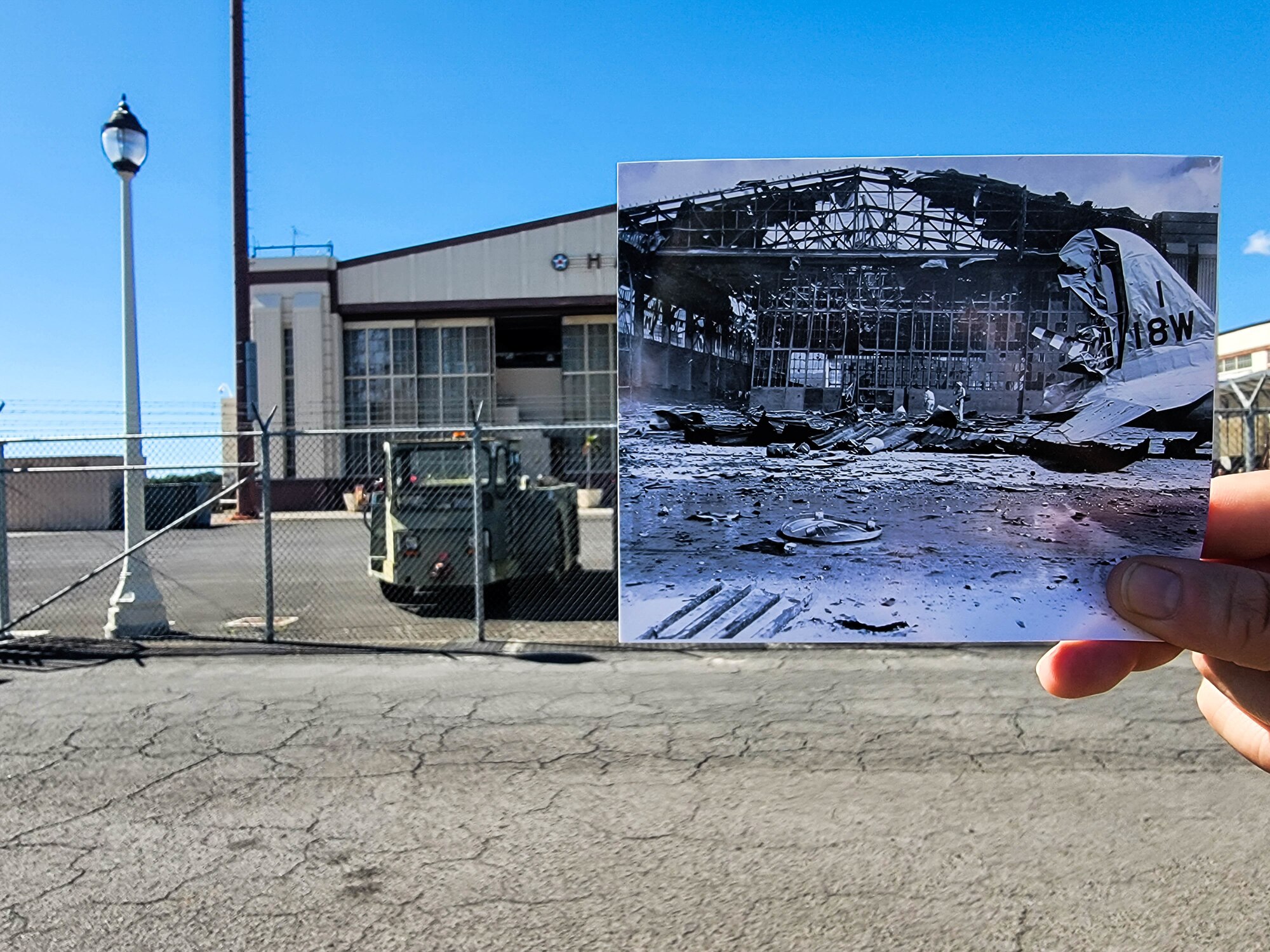 A photo of a hangar taken during the attack on Hickam Field on Dec. 7, 1941, is compared to the current state of the hangar at Joint Base Pearl Harbor-Hickam, Hawaii, Nov. 10, 2021. On a Sunday morning 80 years ago, the largest airborne attack force ever assembled by the Imperial Japanese Navy struck Oahu's military installations. In all, 189 men died, 303 were wounded and nearly half of the aircraft stationed on Hickam were rendered useless. (U.S. Air Force photo by Staff Sgt. Alan Ricker)